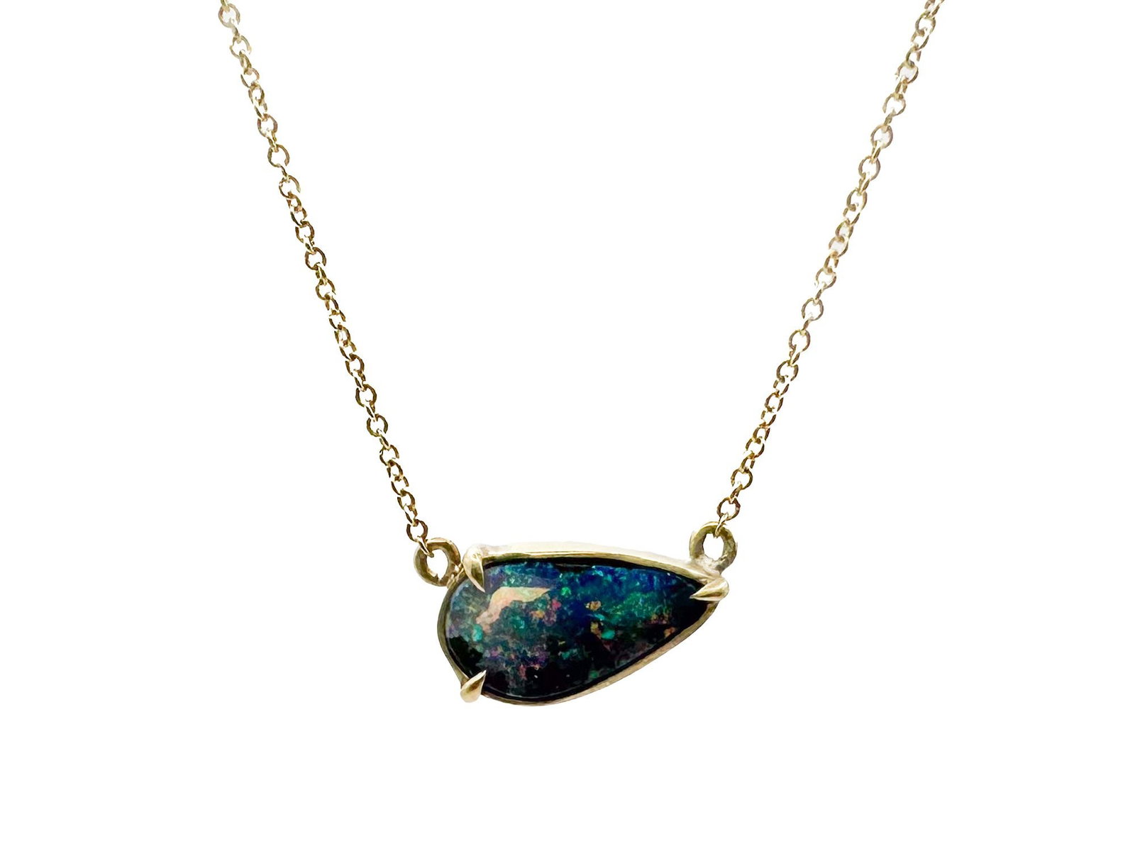 18K Gold Boulder Opal Pendant Necklace: 18K yellow gold necklace featuring a teardrop-shaped boulder opal pendant. Chain is 16 inches long, pendant is 1/2 inch wide. Total weight: 2.2 grams.
