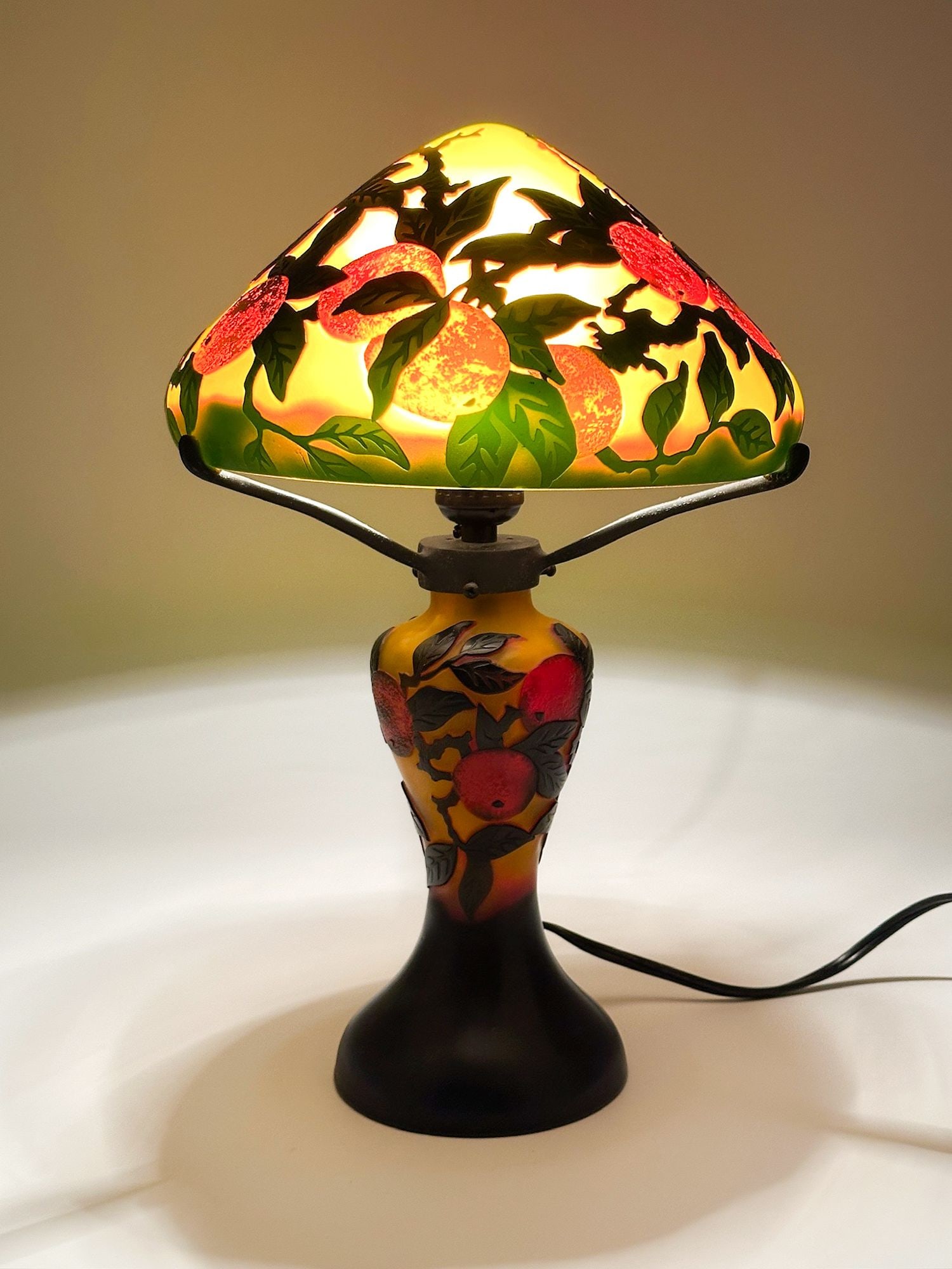 After Emile Galle Art Nouveau Cameo Table Lamp: Made of glass and metal. Lamp features an orange tree and fruit design. Approximately 15 in H x 9.5 in W x 9.5 in D. Weighs approximately 4 lbs 4 oz. LOCAL PICK UP INFORMATION: Wednesday, June 10, 10: