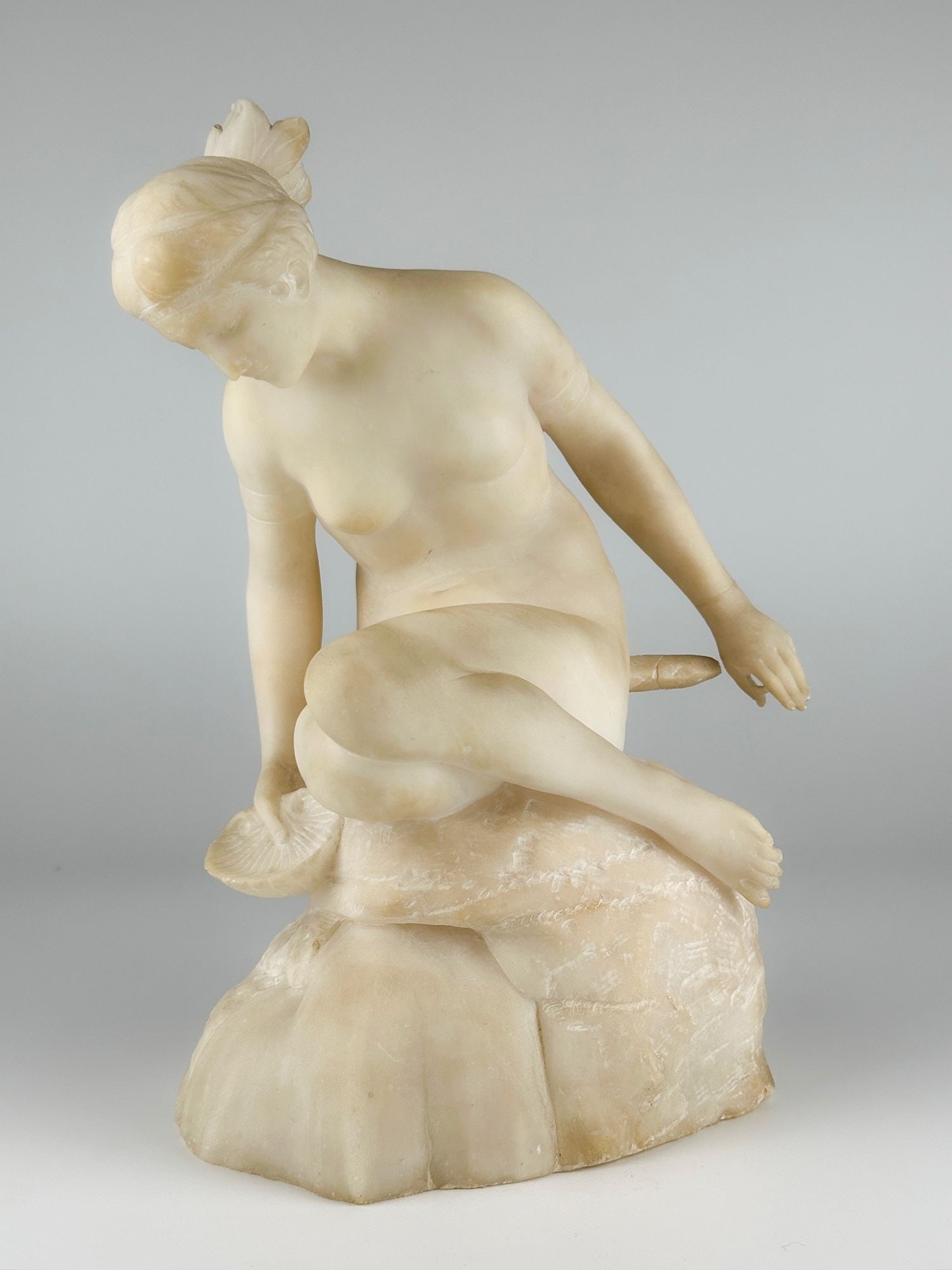 Vintage Alabaster Neoclassical Sculpture of a Woman: Sculpture is made of chiseled alabaster. Depicts a woman sitting on a rock with a shell in hand. Approximately 11.5 in H x 6.5 in W x 8 in D. Weighs approximately 11 lbs 9 oz. LOCAL PICK UP INFORMATIO