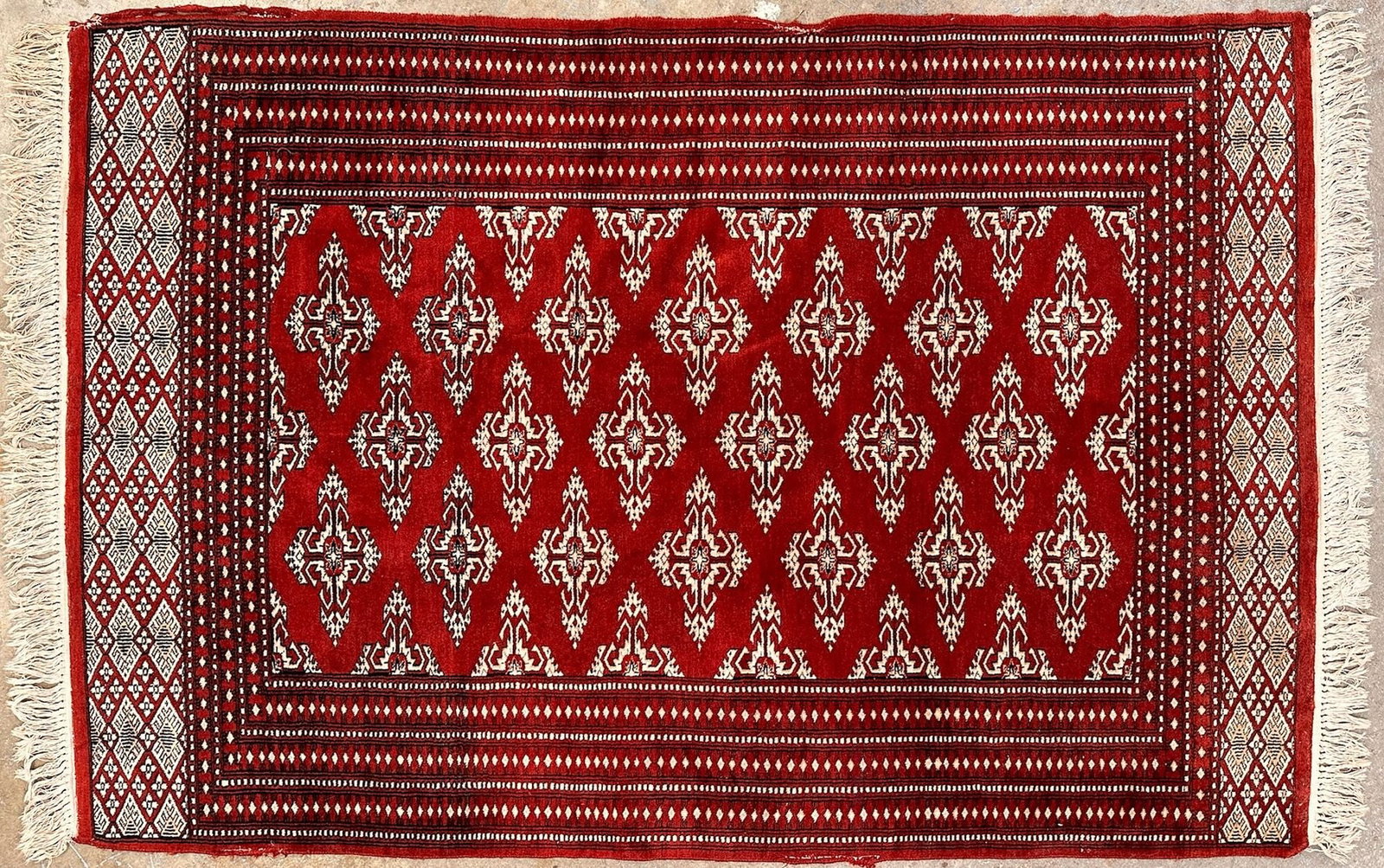 Afghani Bokhara Hand Knotted Wool Rug, 4'2" x 6'10": Red and ivory color. Intricate traditional geometric motif. Hand knotted wool. Dimensions: Rug is approx. 50.5 in L x 82 in W. Weighs 11 lbs 11 oz. LOCAL PICK UP INFORMATION: Wednesday, June 10,