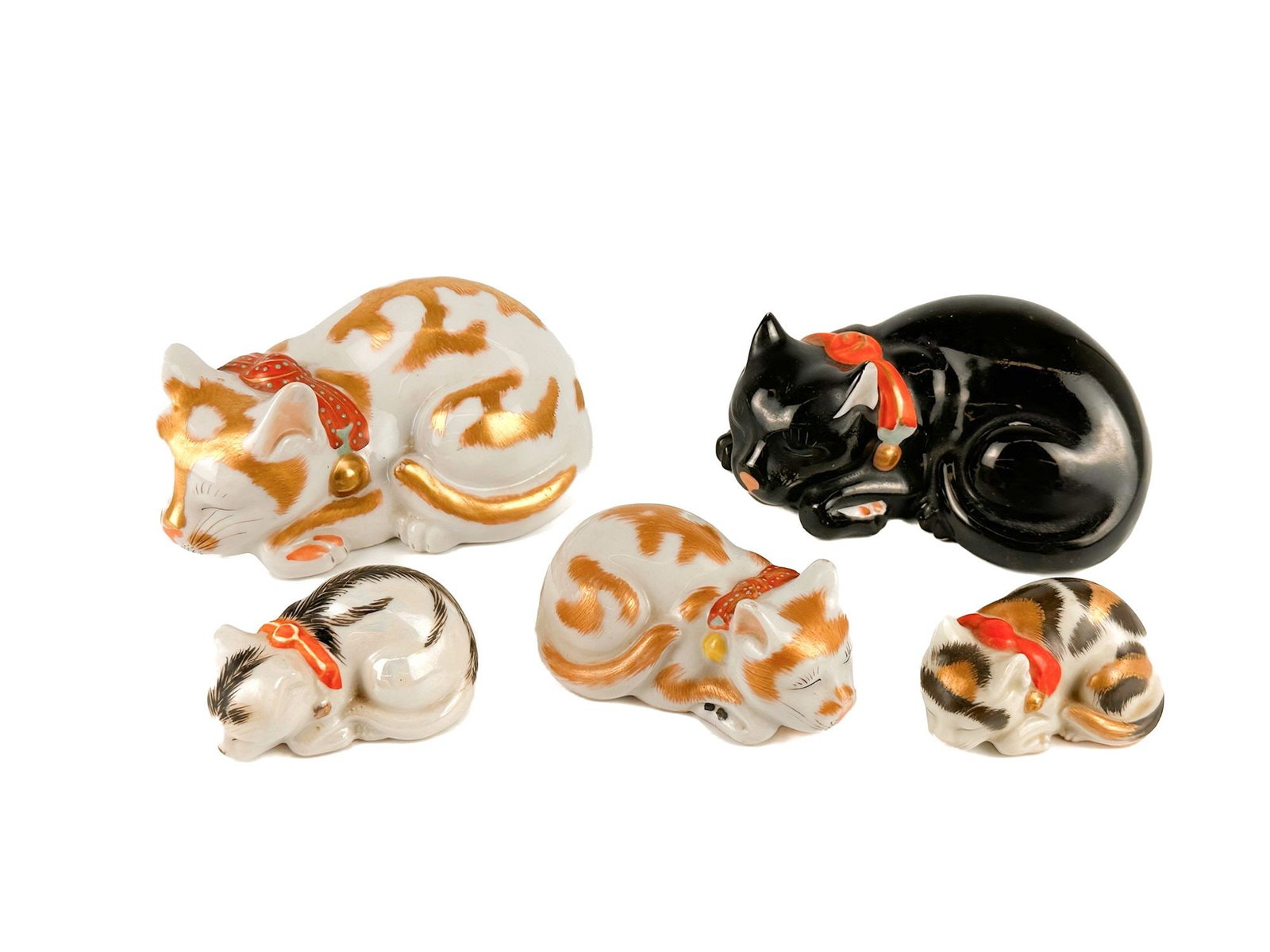 Lot of Five Vintage Japanese Porcelain Nemuri Neko: Porcelain has hand painted details with gold gilding on the fur. Stamped on the bottom, made in Japan. Sculptures depict sleeping cats in various sizes and finishes. Sizes range from approximately 2 i