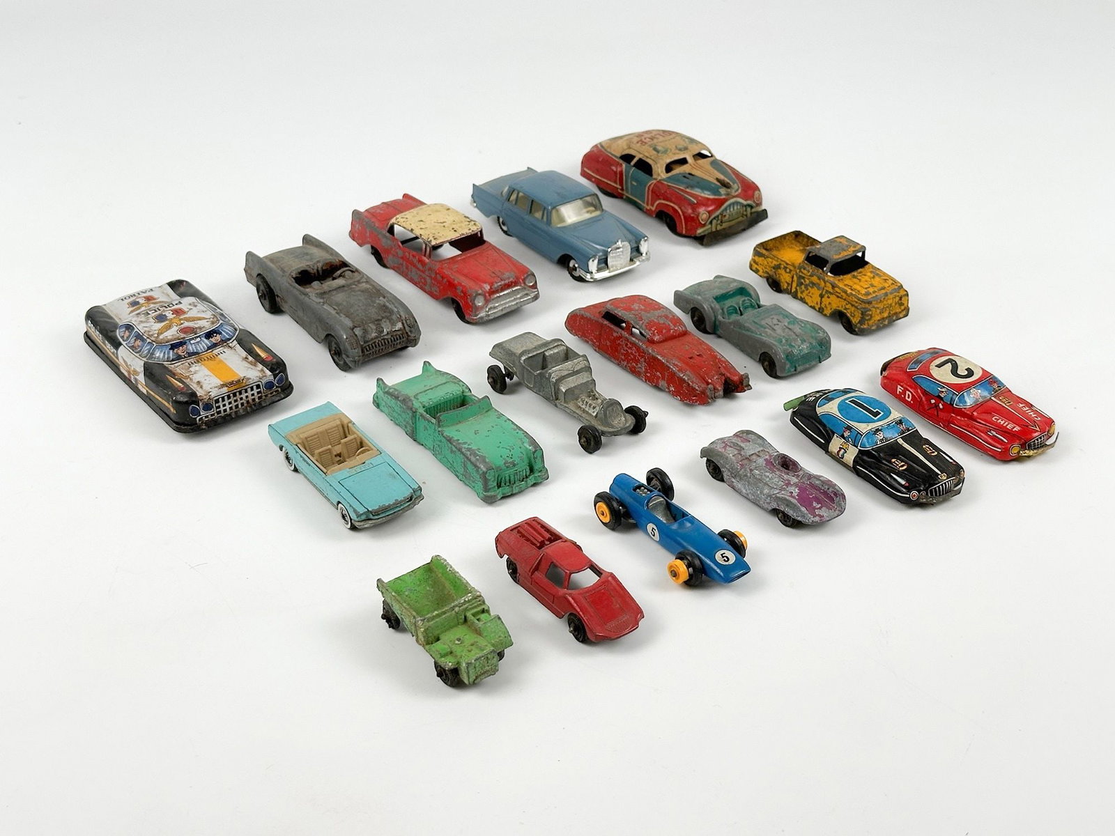 Lot of 17 Vintage Die-Cast Model Cars: Lot includes cars made of metal with rubber tires. Sizes range from approximately 0.75 in H x 1 in W x 2 in D to 0.75 in H x 2 in W x 4 in D. Total weight is approximately 1 lbs 4 oz. LOCAL PICK UP IN