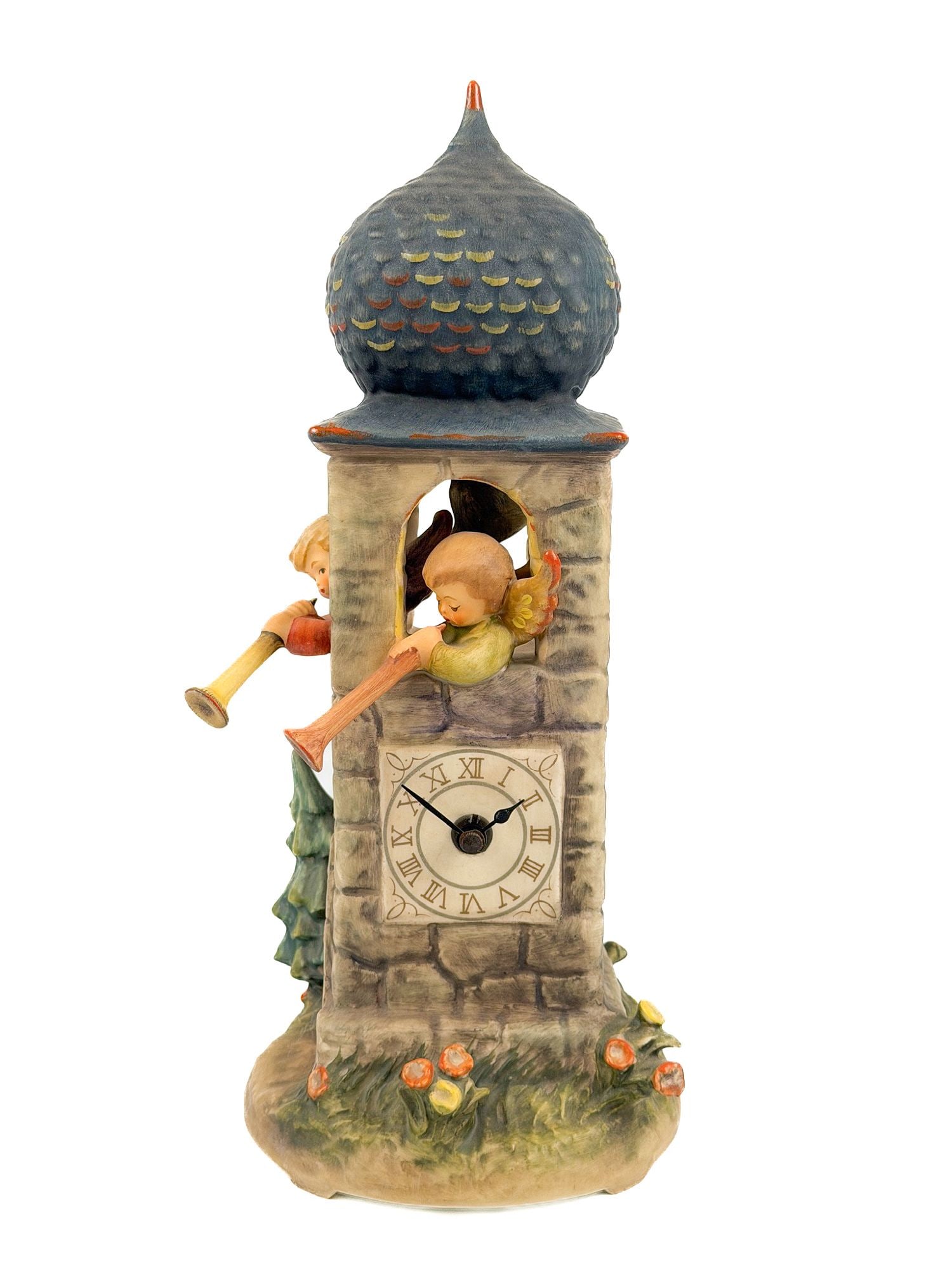 Vintage Goebel M.I. Hummel Ceramic Clock, 1988: Titled Call to Worship. Signed on the base and stamped on the bottom. Features two angels blowing horns from the top of a clock tower. Approximately 13.25 in H x 6 in W x 5.25 in D. Weighs approximate