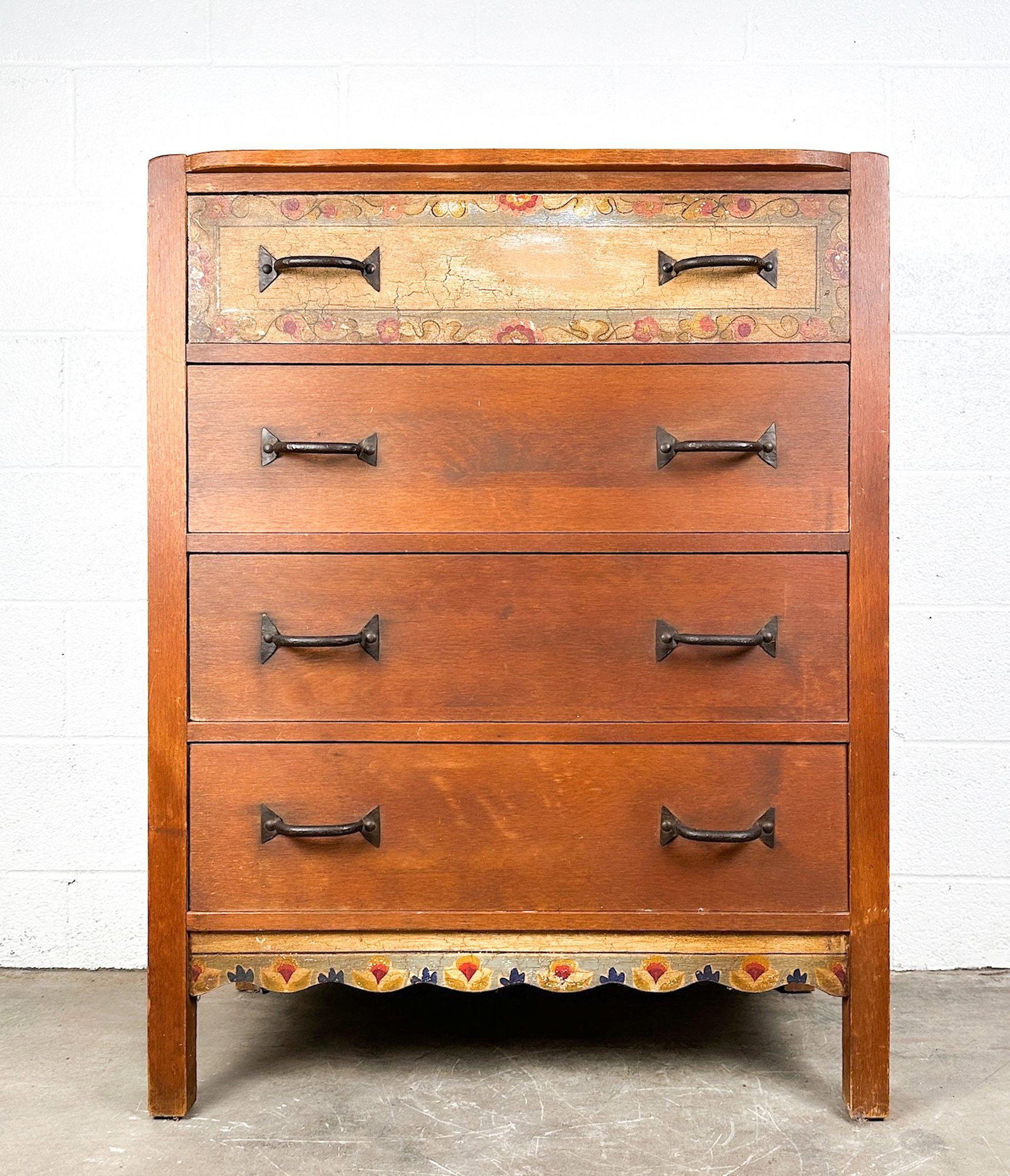 Monterey Furniture 4-Drawer Dresser with Hand-Painted Floral Motif: Features hand painted floral motif on top drawer and bottom trim. Wrought iron handle pulls. Monterey mark on back. Dimensions: Dresser is approx. 42.5 in H x 34.5 in W x 18.5 in D. LOCAL PICK UP