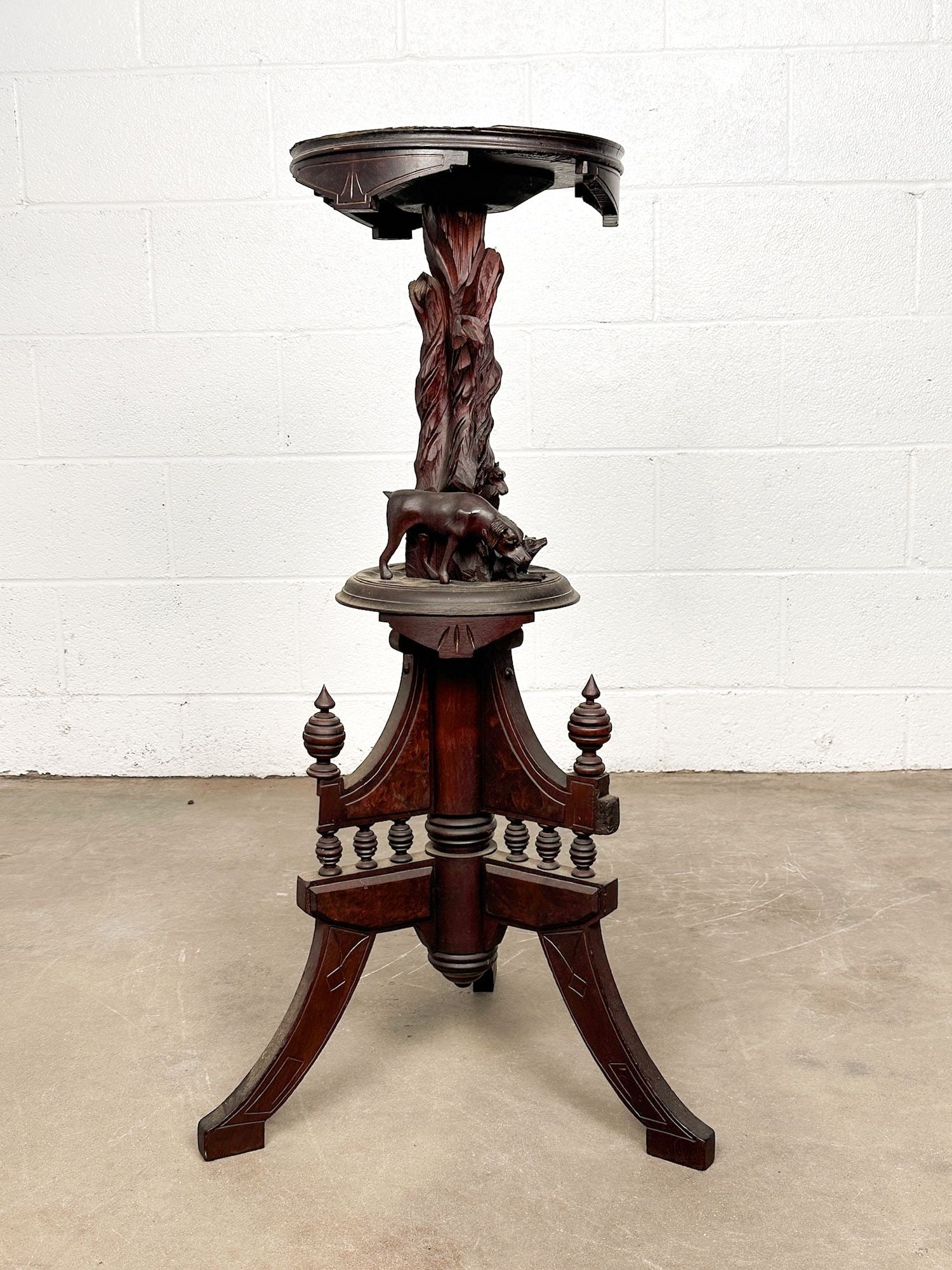 Antique Black Forest Carved Wood Plant Stand Pedestal with Dogs and Branches: Carvings depict 3 dogs and branches. Burlwood on base. Dimensions: Plant stand is approx. 35 in H x 19 in Dia. Weighs 10 lbs 3 oz. LOCAL PICK UP INFORMATION: Wednesday, July 8, 10:00 AM - 2:00 PM 8059