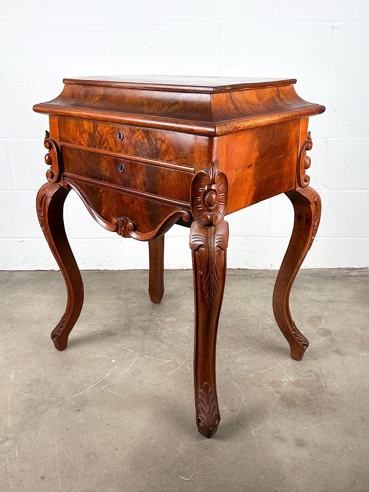 Antique Burlwood Sewing Stand with Cabriole Legs and Mirror: Cabriole legs with carving. Top opens to reveal mirror. Burlwood accents. Dimensions: Table is approx. 32 in H x 25 in W x 18 in D. LOCAL PICK UP INFORMATION: Wednesday, July 8, 10:00 AM - 2:00 PM 805