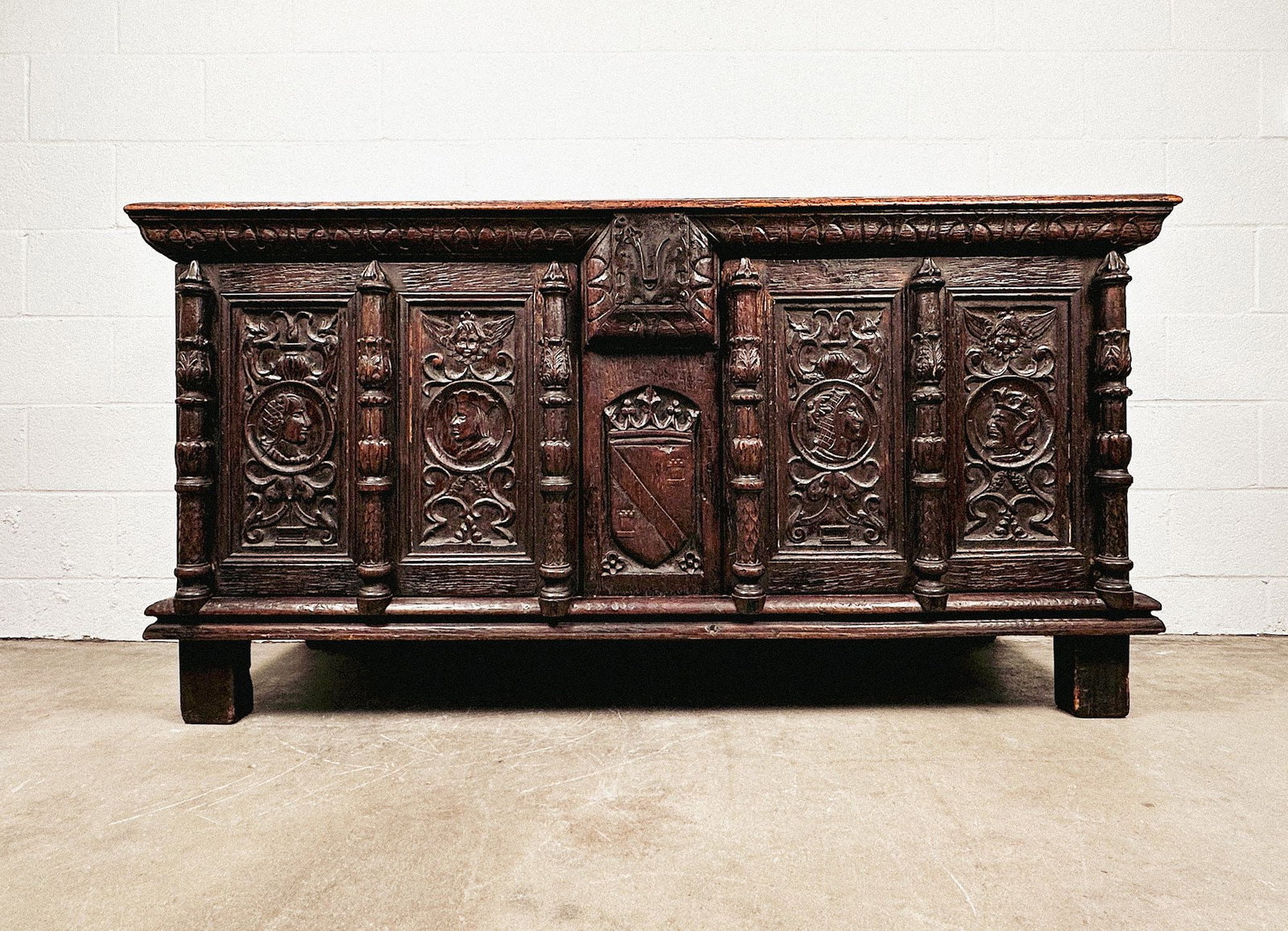 Renaissance Revival Carved Oak Chest with Portraits and Heraldry: 2 doors with ample storage space. Cameo portrait carvings on front. Metal plate on front. Dimensions: Hutch is approx. 33.5 in H x 66 in W x 22.5 in D. LOCAL PICK UP INFORMATION: Wednesday, July 8, 10