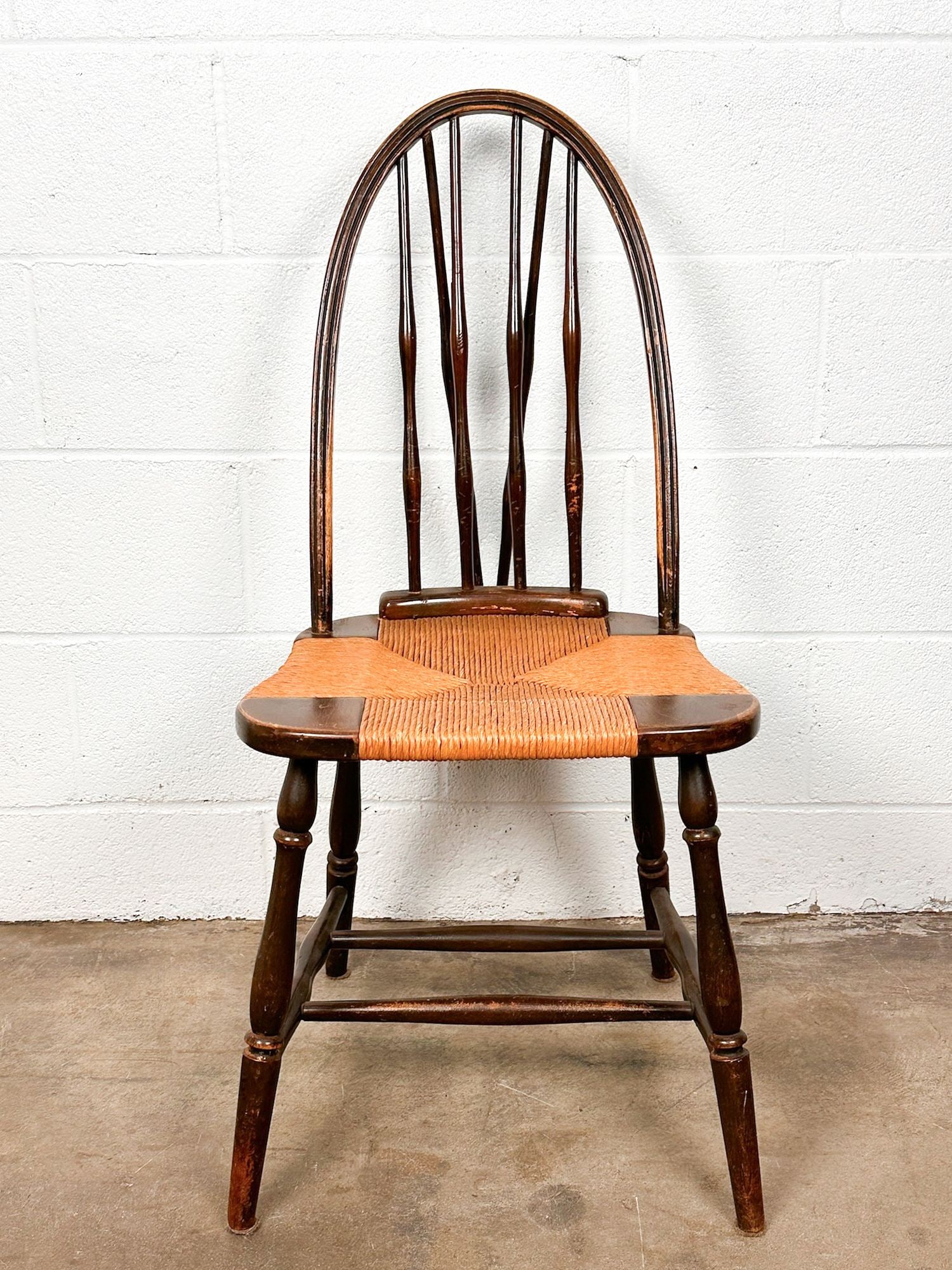 Antique English Windsor Walnut and Rush Seat Chair: Chair is constructed of a rush seat and walnut wood frame. No stamp. Approximately 35.75 in H x 17 in W x 18.5 in D. Seat height is approximately 17.5 in. Weighs approximately 8 lbs 10 oz. LOCAL PICK 