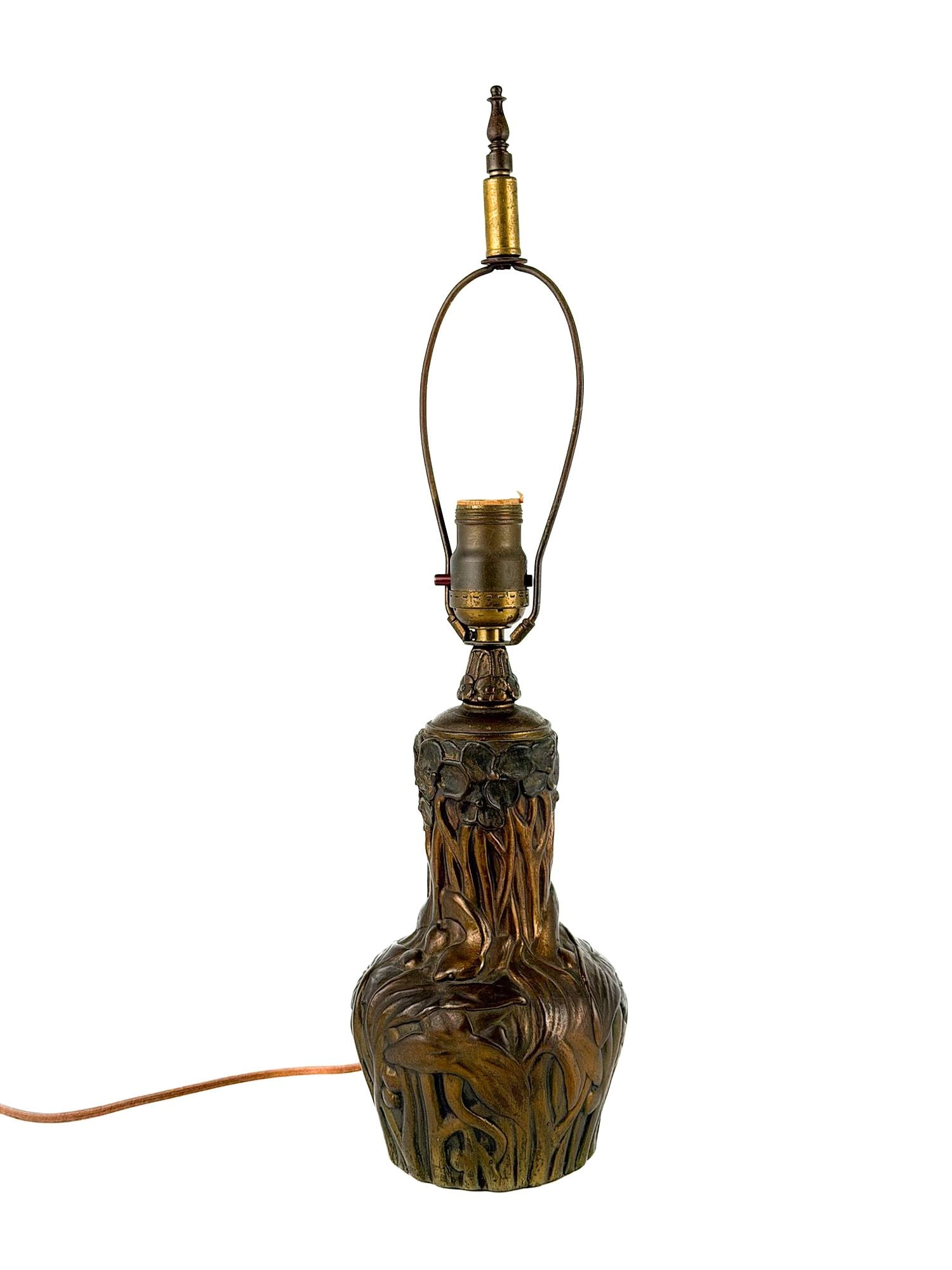 Art Nouveau Patinated Cast Metal Table Lamp Base, Irises and Poppies: Art Nouveau table lamp base, American, circa 1910s-1920s, the baluster body cast in relief with irises, poppies, and tall marsh grasses/foliage. Approx dimensions: 20.25 in H x 5 in Dia. Weight: 5 lb 
