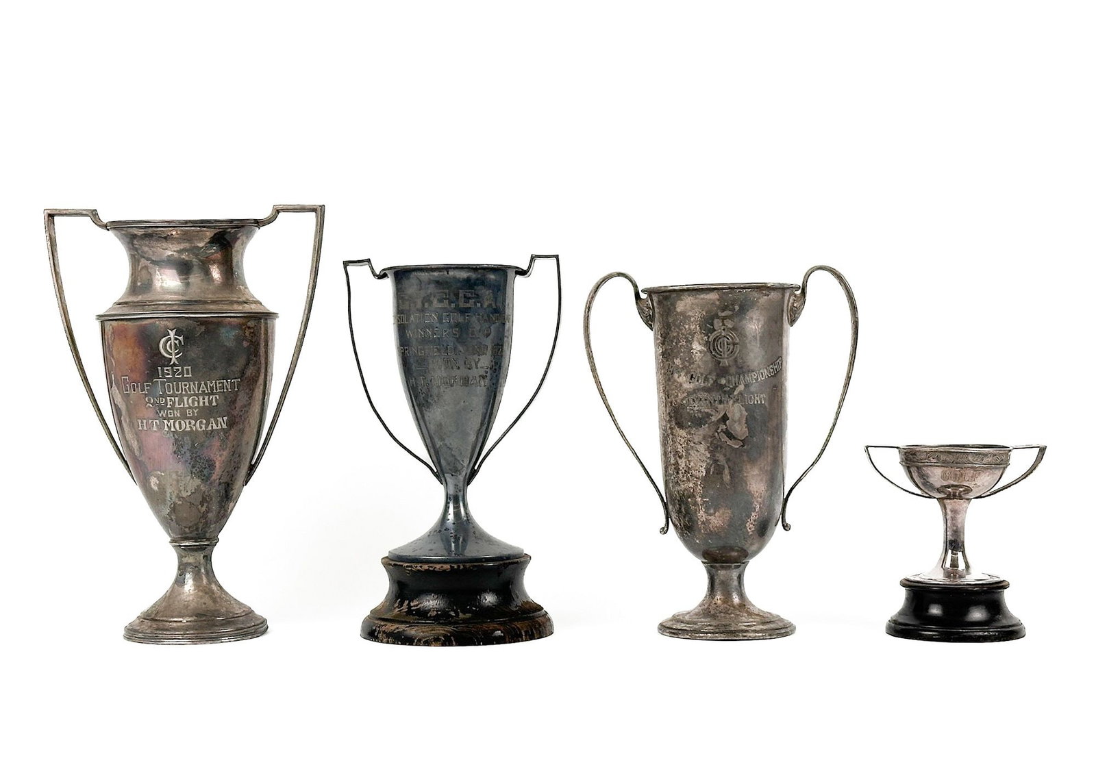 Group of 4 Antique Golf Tournament Trophies: Group of trophies from the 1910s and 1920s. Dimensions: Sizes range 5.25 - 12.25 in H x 5 - 8 in W x 3.75 - 5.25 in D. Weighs 5 lbs 5 oz. LOCAL PICK UP INFORMATION: Wednesday, July 8, 10:00 AM - 2:00 