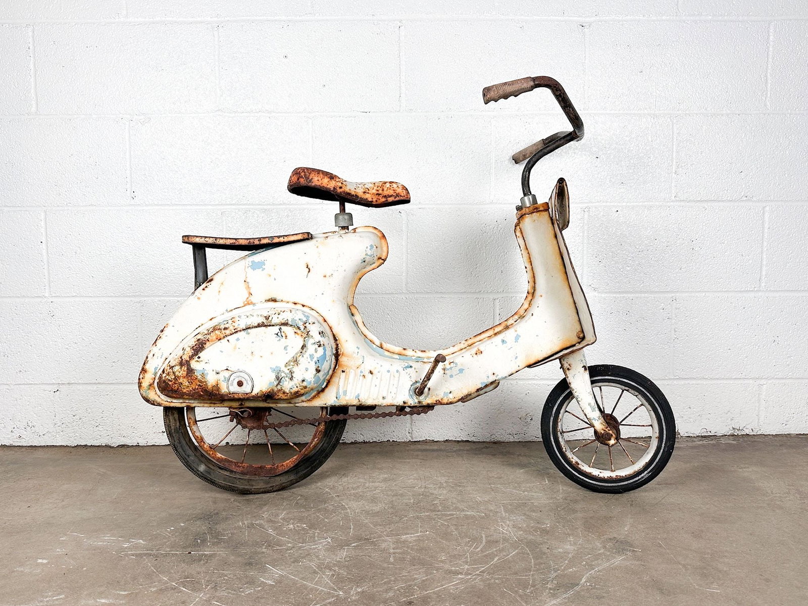 Vintage 1950s Super Sonda Vespa Style Children's Pedal Scooter: Vintage 1950s children's pedal scooter. Vespa style body. Nice patina throughout. Dimensions: Scooter is approx. 27 in H x 8 in W x 39 in D. Weighs 25 lbs. LOCAL PICK UP INFORMATION: Wednesday, July 8