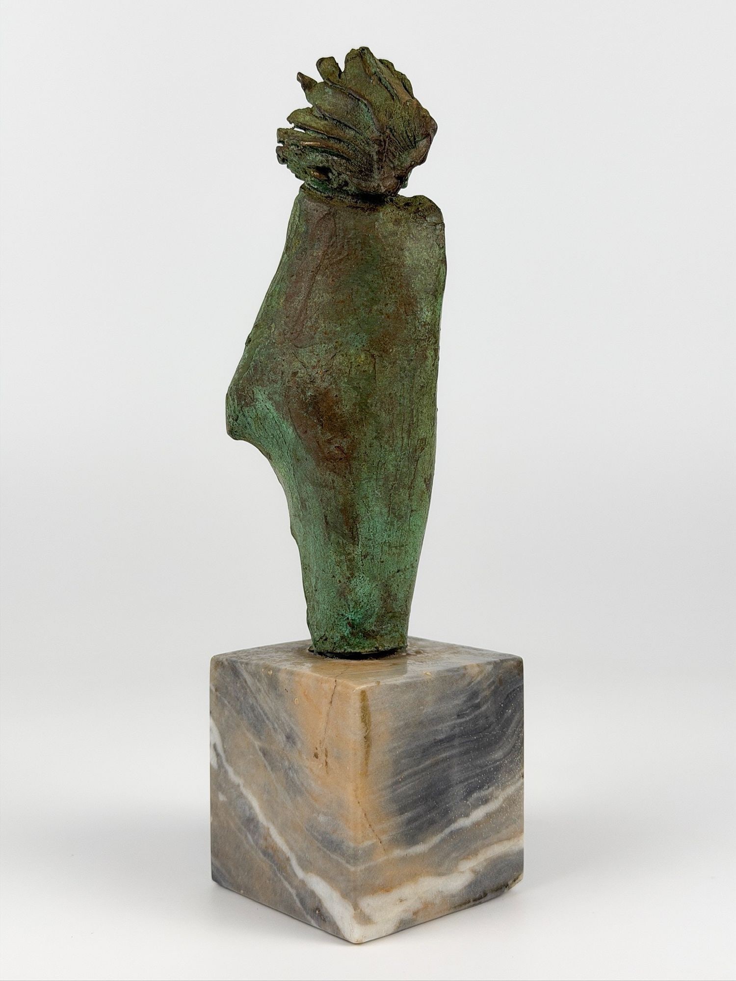 Modernist Bronze Female Figure with Patina on Marble Cube Base: Green patina. Mounted onto a block of marble. Depicts an abstracted form with body shroud and extended facial features. No signature. Approximately 9 in H x 2.5 in W x 2.75 in D. Approximately 2 lbs 1