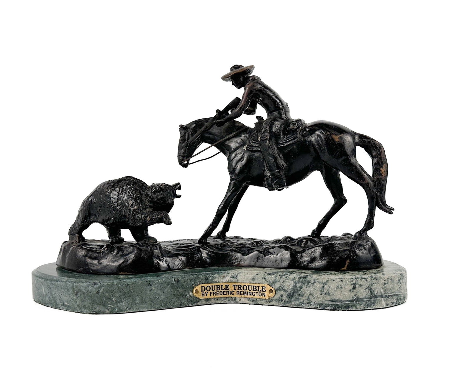Frederic Remington Double Trouble Cast Bronze Sculpture 10/100: Cast bronze sculpture depicting cowboy and bear. Plaque on front with title and artist name. Green marble base. Numbered and signed on back. Dimensions: Sculpture is approx. 9.75 in H x 15 in W x 7.25