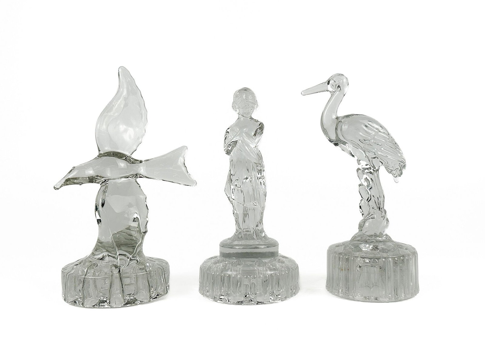 Group of Three Vintage Crystal Glass Figurines: Bird, Woman, and Heron: Group of 3 1920s/1930s glass flower frogs. Dimensions: Sizes range approx. 8.5 - 9.5 in H x 3.5 - 4 in dia. Weighs 5 lbs 9 oz. LOCAL PICK UP INFORMATION: Wednesday, July 8, 10:00 AM - 2:00 PM 8059 Foo