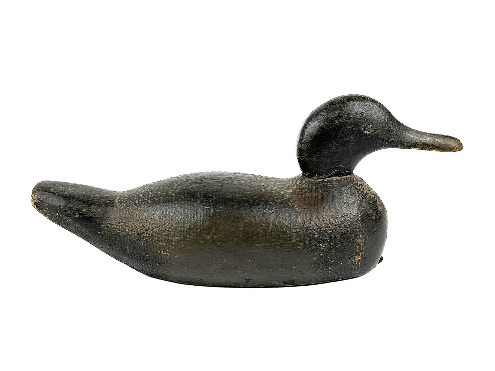 Antique Hand Carved Wooden Duck Decoy, Tuveson Mfg, MN: Made by Tuveson Manufacturing, St. James, MN. Made of hand carved wood with leather pulls on the bottom. Depicts a model of a duck. Approximately 6.5 in H x 16.5 in W x 5 in D. Weighs approximately 2 