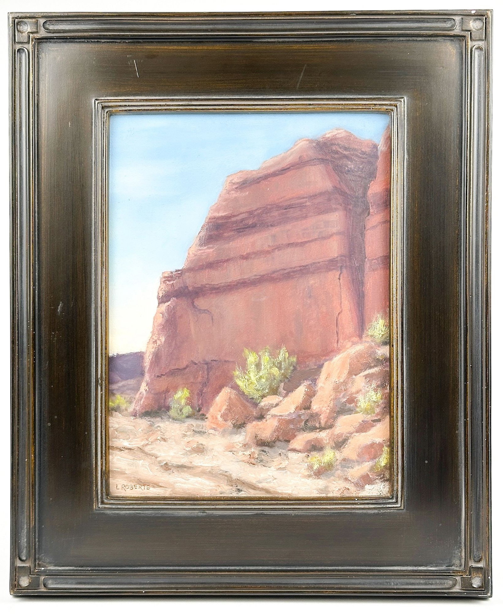 L. Roberts (20th Century) Oil on Masonite, Desert Mesa: Signed in the lower left corner. Depicts the shady side of a large red stone bluff in a desert. Framed. Visible image is approximately 11.5 in H x 8.5 in W. Frame is approximately 17.5 in H x 14.5 in 