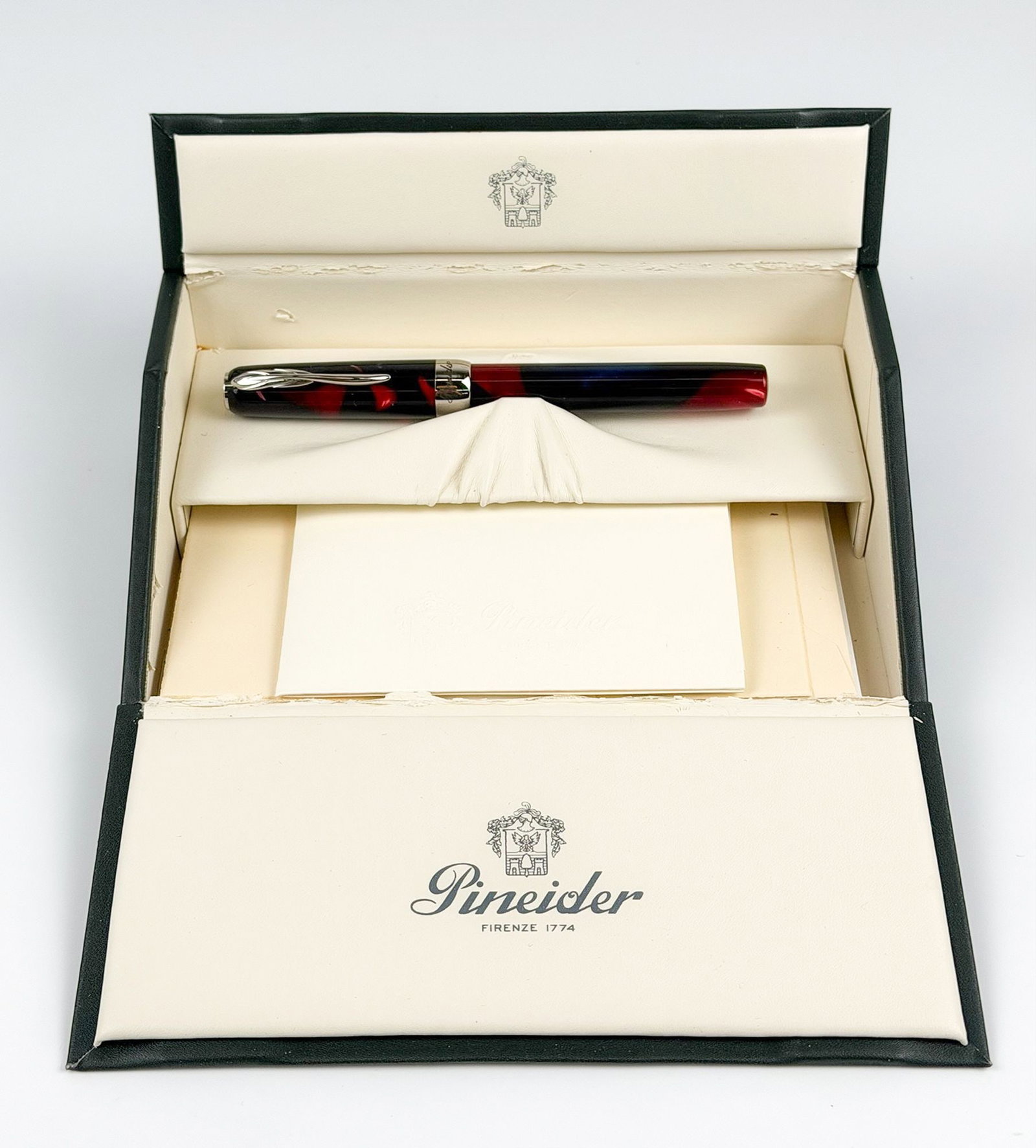 PINEIDER Firenze 1774 La Grande Bellezza Fountain Pen with Presentation Box: A Pineider Firenze 1774 fountain pen in a presentation box. The pen features a marbled red and dark blue barrel with silver-tone trim and clip. Nib is 18k gold. Includes original case, paperwork, and 