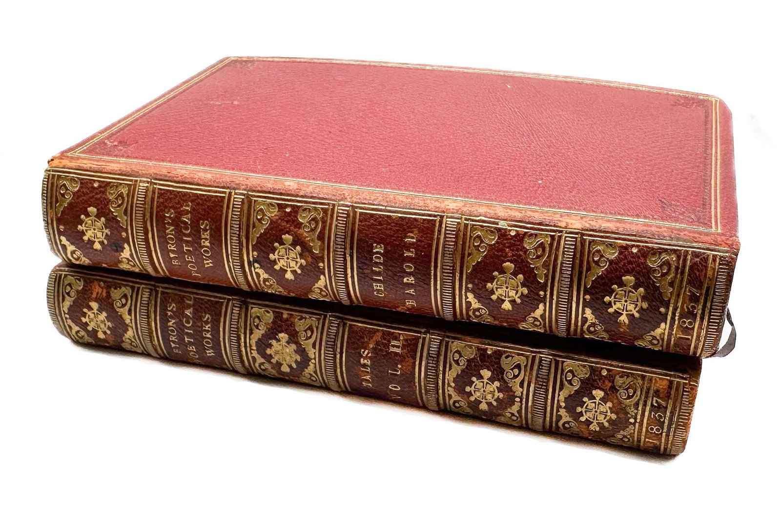 Lord Byron. Byron's Poetical Works, 2 vols. Childe Harold's Pilgrimage & Tales, London 1837: A two-volume set bound in rich crimson leather with elaborately gilt-tooled spines, featuring peacock-pattern marbled endpapers and a binder's ticket from Charles Thurnam & Sons of Carlisle. A dec