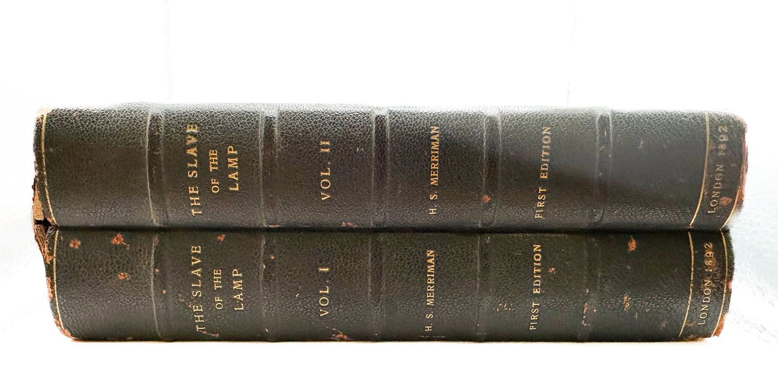 Henry Seton Merriman. First Edition, 2 vols. The Slave of the Lamp. London: Smith, Elder, & Co.,: A first edition in the original sage-green publisher's cloth with Art Nouveau-influenced gilt lettering, accompanied by a typed bookseller's slip crediting Merriman as originator of the 'strong silent