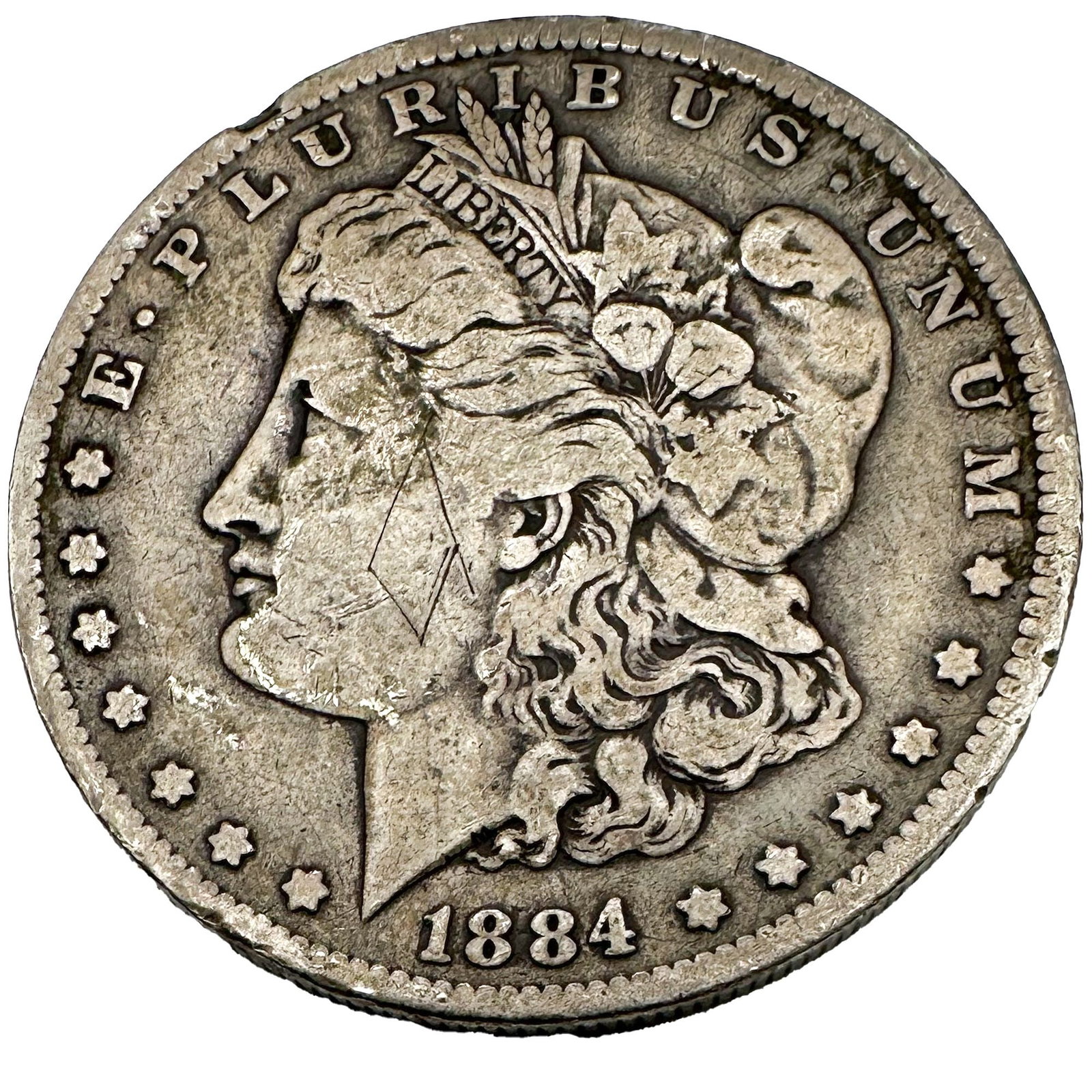 1884-O Morgan Dollar: An 1884-O Morgan dollar from the New Orleans Mint. A common-date circulated issue. Shipping & Handling. All lots won by the same bidder are combined into one shipment via USPS Priority Mail (tracking 