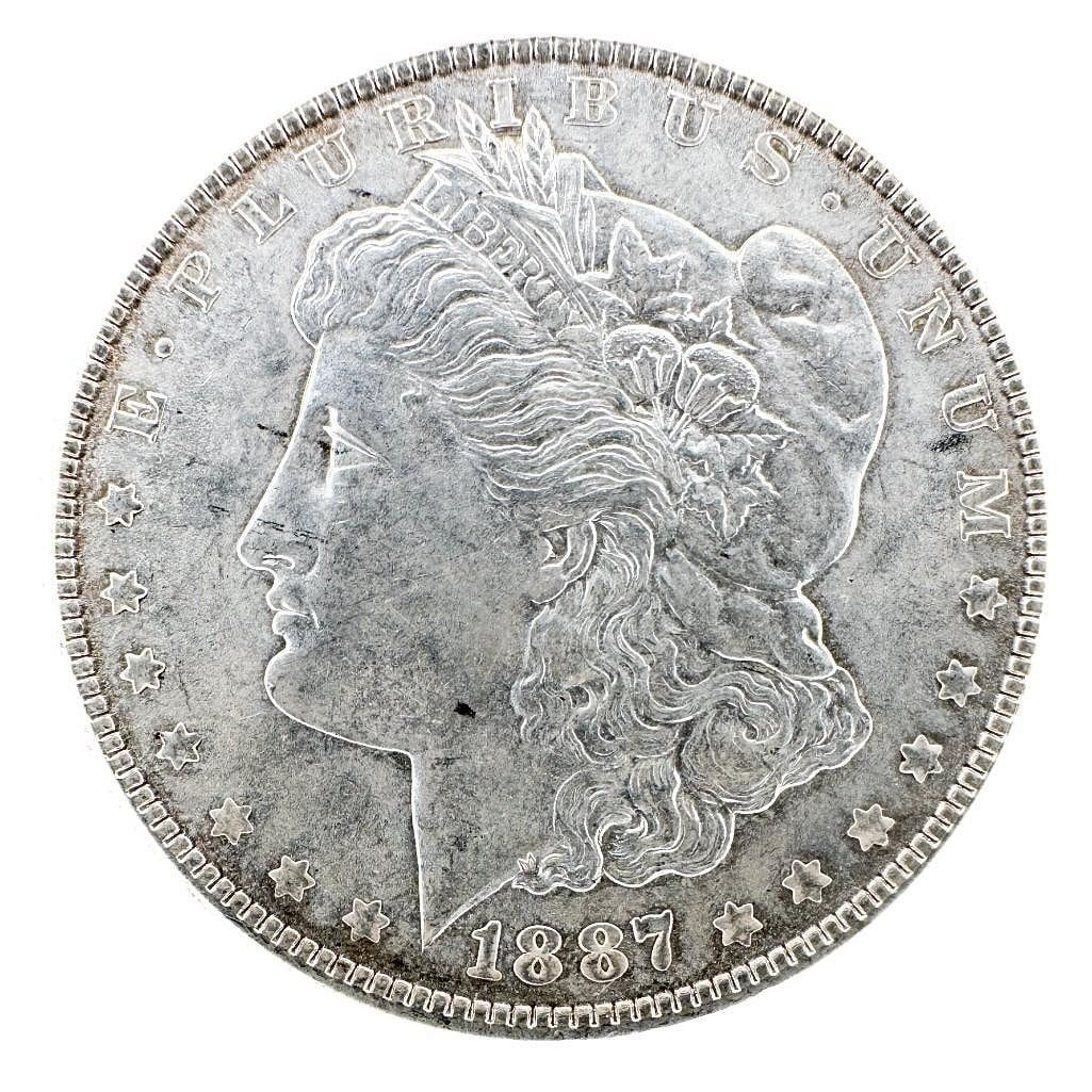 1887 Morgan Silver Dollar: An 1887 Morgan dollar, a common Philadelphia Mint issue. A circulated example of the classic design. Shipping & Handling. All lots won by the same bidder are combined into one shipment via USPS Priori