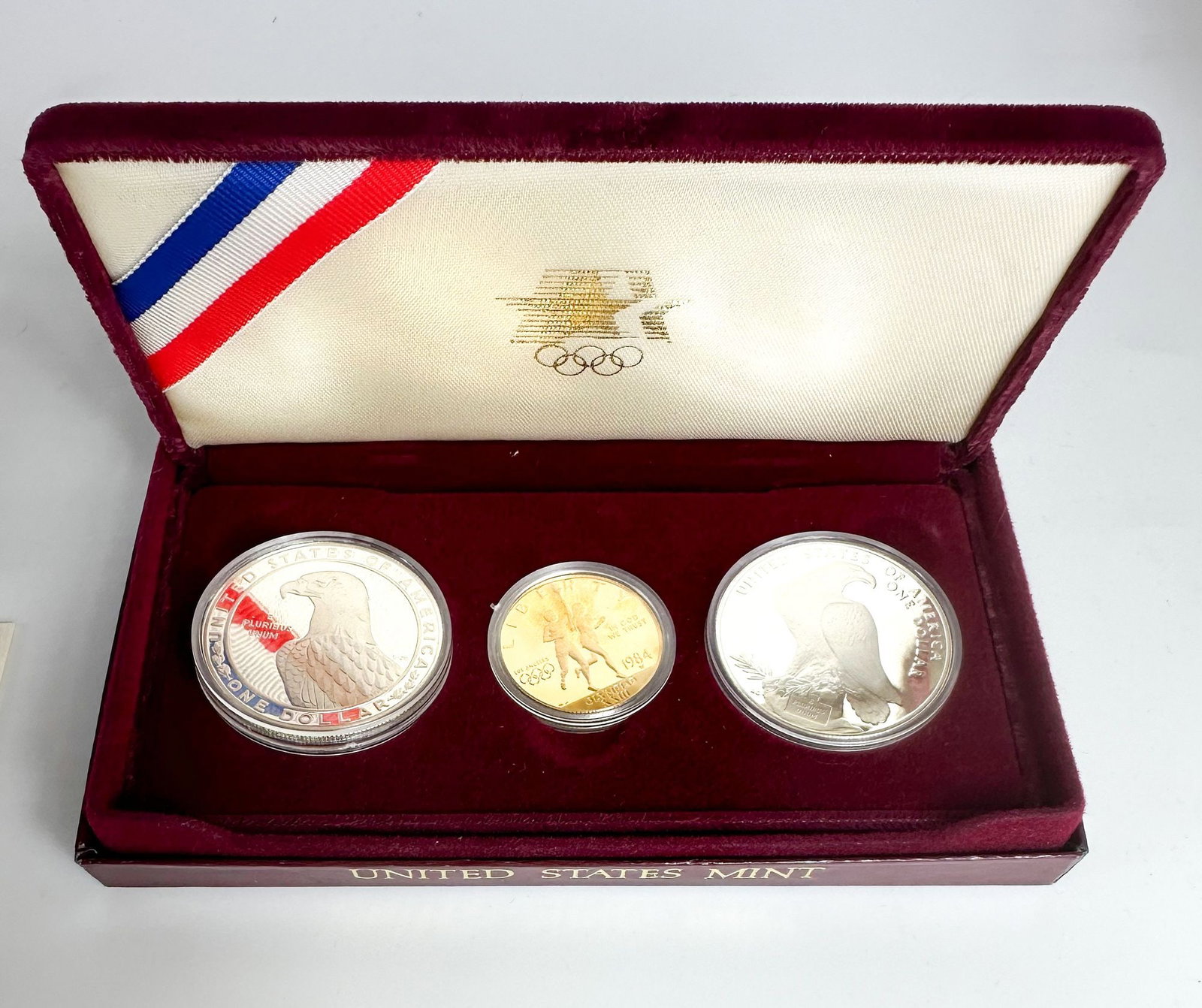 1984 LA Olympics Three-Coin Proof Set with $10 Gold: A 1984 Los Angeles Olympics three-coin proof set with a $10 commemorative plus 1983 and 1984 dollars. A flagship U.S. Olympic commemorative issue. Shipping & Handling. All lots won by the same bidder 