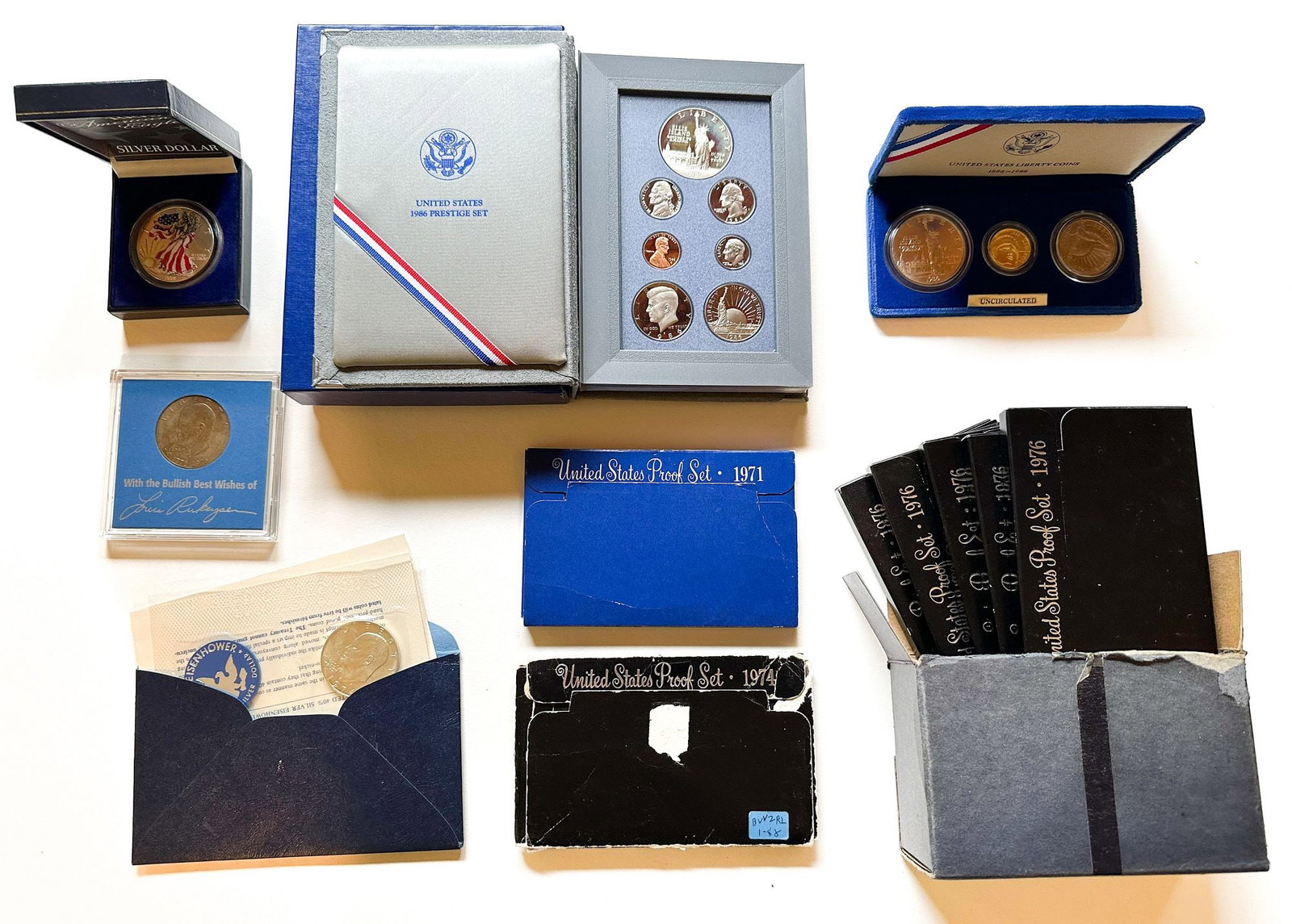 U.S. Mint Proof & Commemorative Coin Collection: A group lot including a 1986 Statue of Liberty Prestige set, 1986-88 Liberty coins, 1971/1974/1976 proof sets, Eisenhower dollars and a colorized Eagle. A varied accumulation of U.S. Mint proof and co