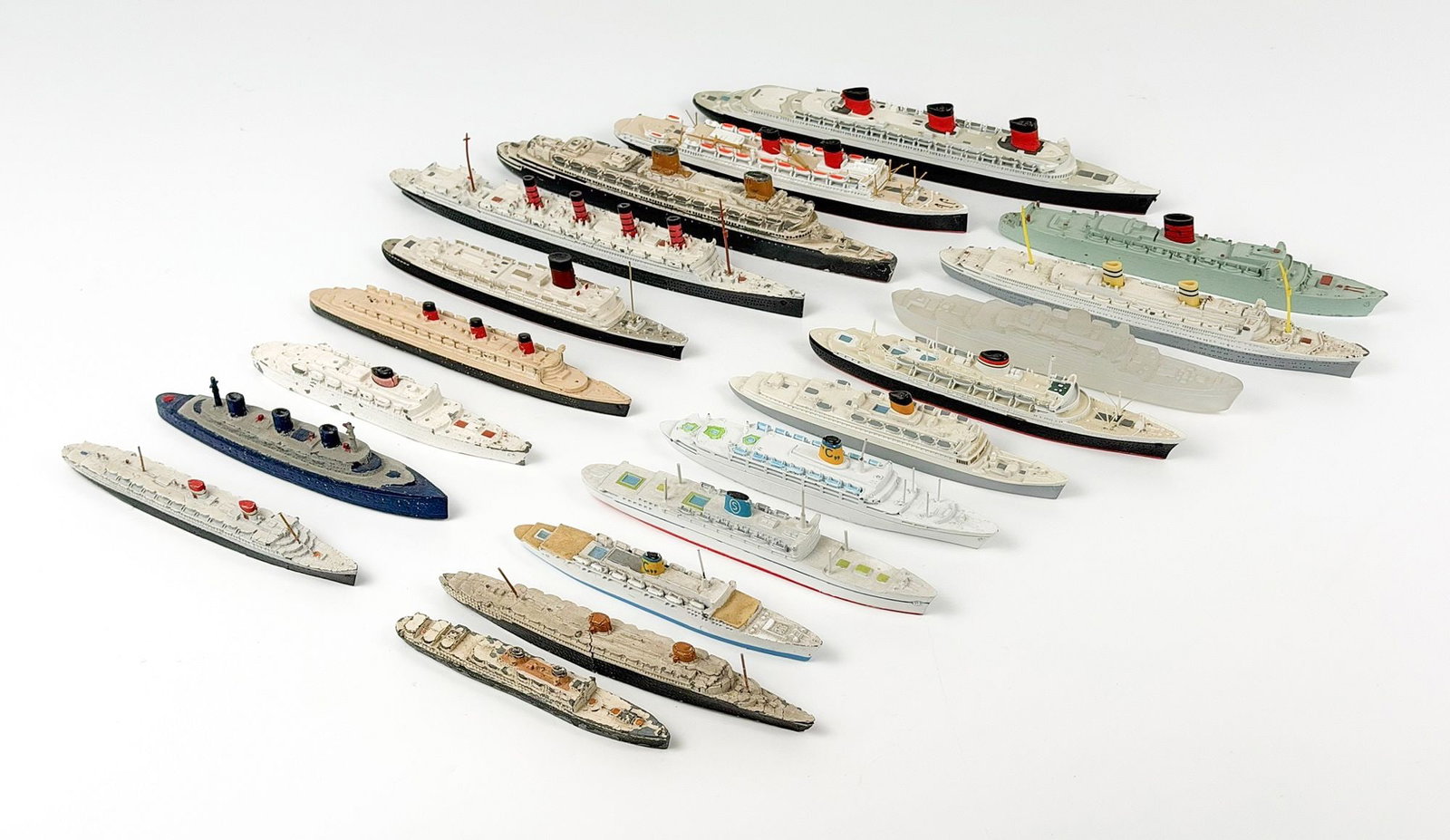 Lot of 19 Miniature Die Cast Model Ocean Liner Ships: Lot includes models of ships such as RMS Aquatania, RMS Caronia, SS Nieuw Amsterdam, SS Normandie, and many more. Dimensions: Approx. range: 1.5 in H x 10 in W x 1.25 in D. to 0.75 in H x 4.5 in W x