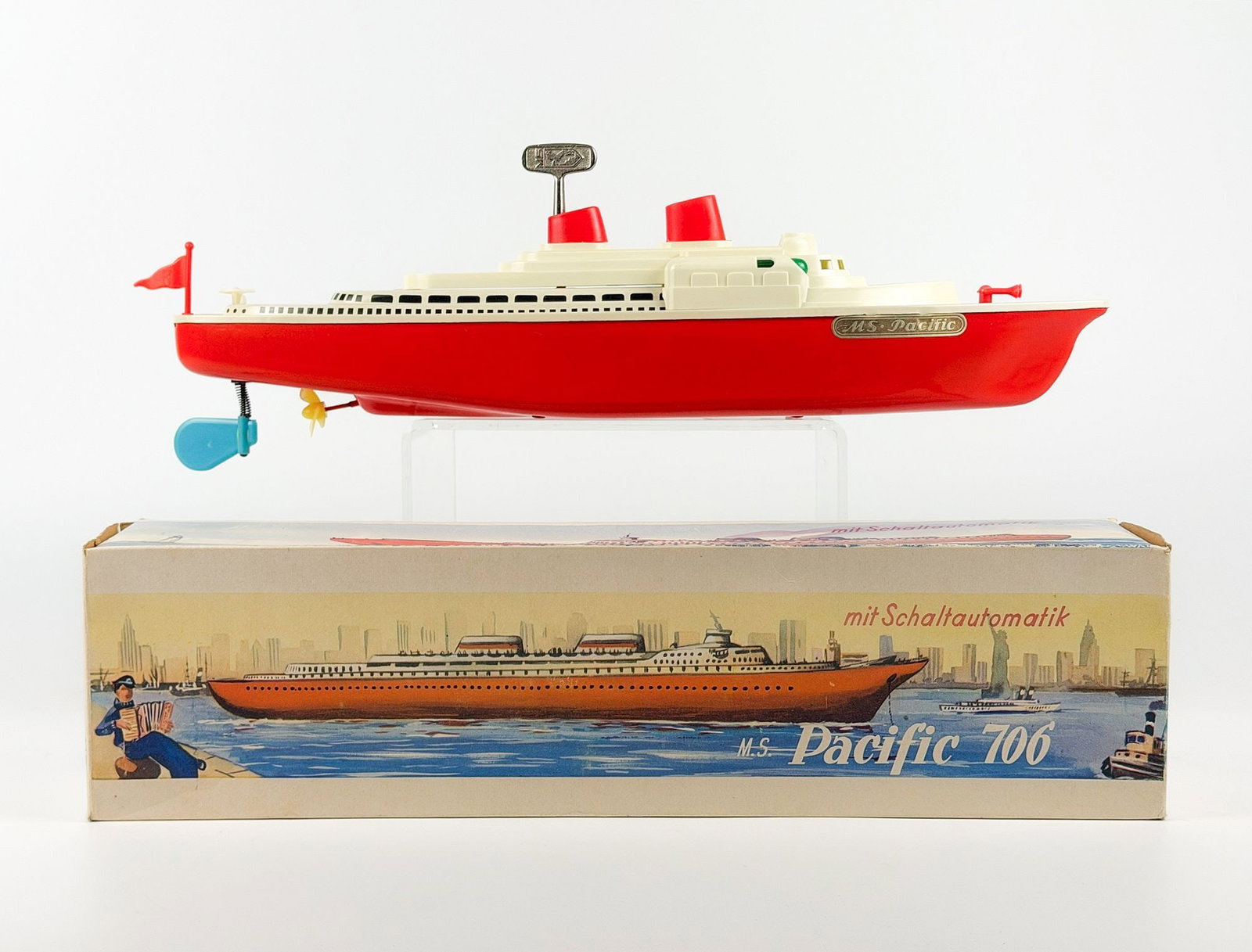 German Made MS Pacific 706 Wind Up Tin Toy Ship with Box: Includes original box and key. Main hull is made of tin while upper deck, propeller, and small details are plastic. Dimensions: Approx.4.5 in H x 17 in W x 3 in D. Weight: 1 lb 5 oz.