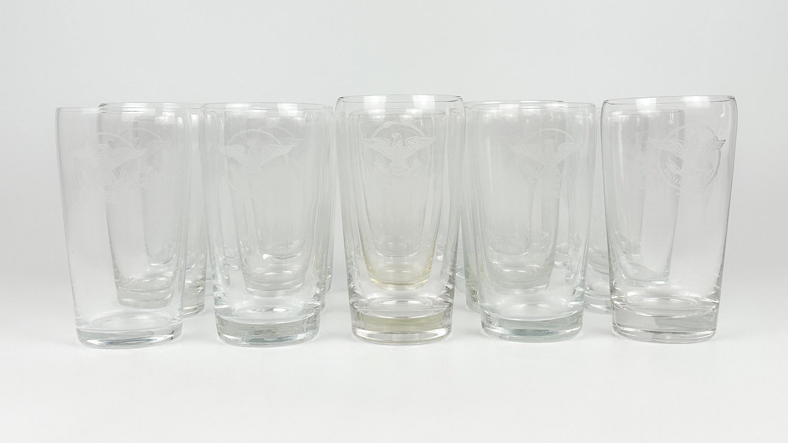 SS United States Highballs Glasses w/ United States Line Eagle Logo (15): 15 glasses with etched US Lines eagle logo. Dimensions: Each shot glass is approx. 4.75 in H x 2.5 in Dia.Weighs 6lbs 4 oz.