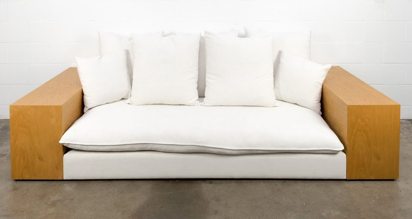 Topa Topa Sofa by House of Leon with Wood Veneer Sides: White cotton upholstery with wood veneer table sides. Features seven plush down feather pillows. Dimensions: Approximately 26 in H x 102.5 in W x 39.5 in D. LOCAL PICK UP INFORMATION:Wednesday, Septem
