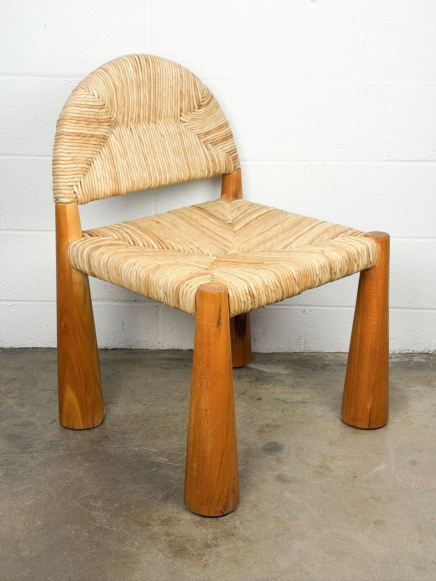 Laredo Chair, Teak and Rattan: Chunky natural teak wood with woven straw. Dimensions: Approximately 33 in H x 22 in W x 21 in D. Weighs approximately 30 lbs. LOCAL PICK UP INFORMATION:Wednesday, September 16, 10:00 AM-2:00 PM at 80