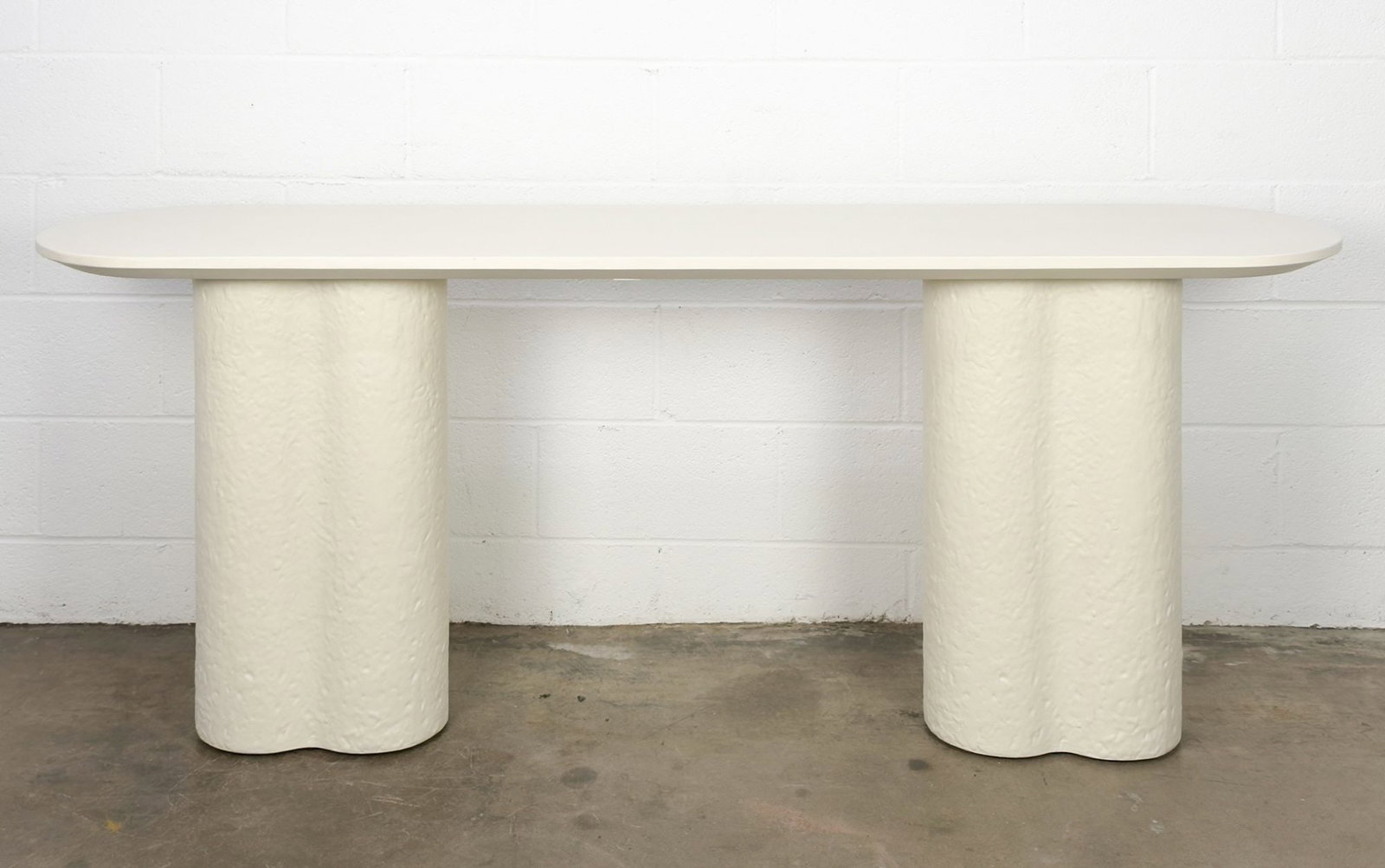 Sarah Sherman Samuel for Lulu and Georgia Tatia Console Table: Designed by Sarah Sherman Samuel. Made of white fiber stone. Features an oval top and textured, clover-style legs. Dimensions: Approximately 29 in H x 72 in W x 16 in D. Weighs approximately 190 lbs. 