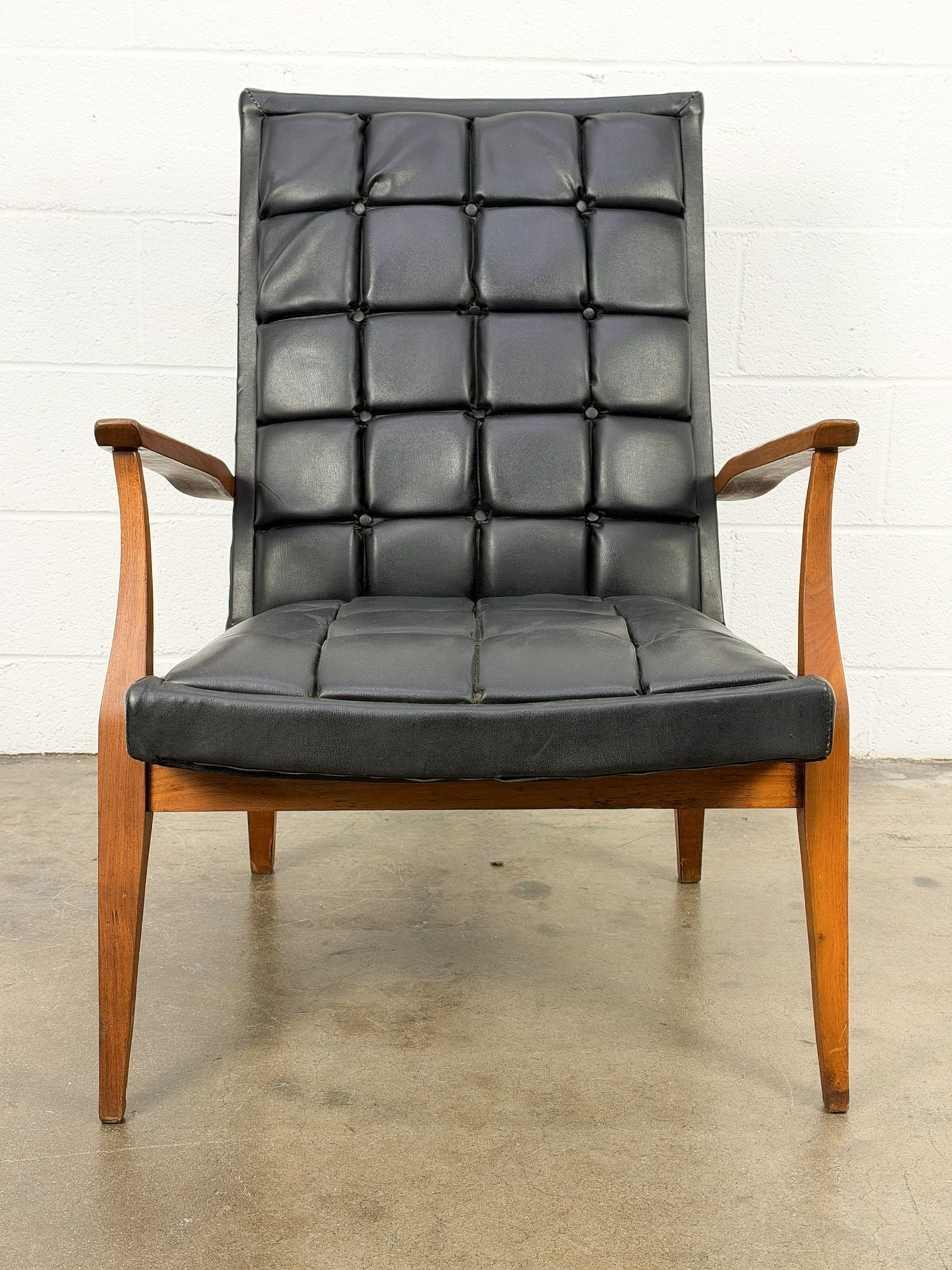 Gil's Find: Midcentury Modern Tufted Leather Accent Chair: Black leather upholstery with sleek wooden legs and arm rests. Dimensions: Approx dimensions: 35 in H x 25 in W x 38 in D. Seat height: 15 in H. LOCAL PICK UP INFORMATION:Wednesday, September 16,