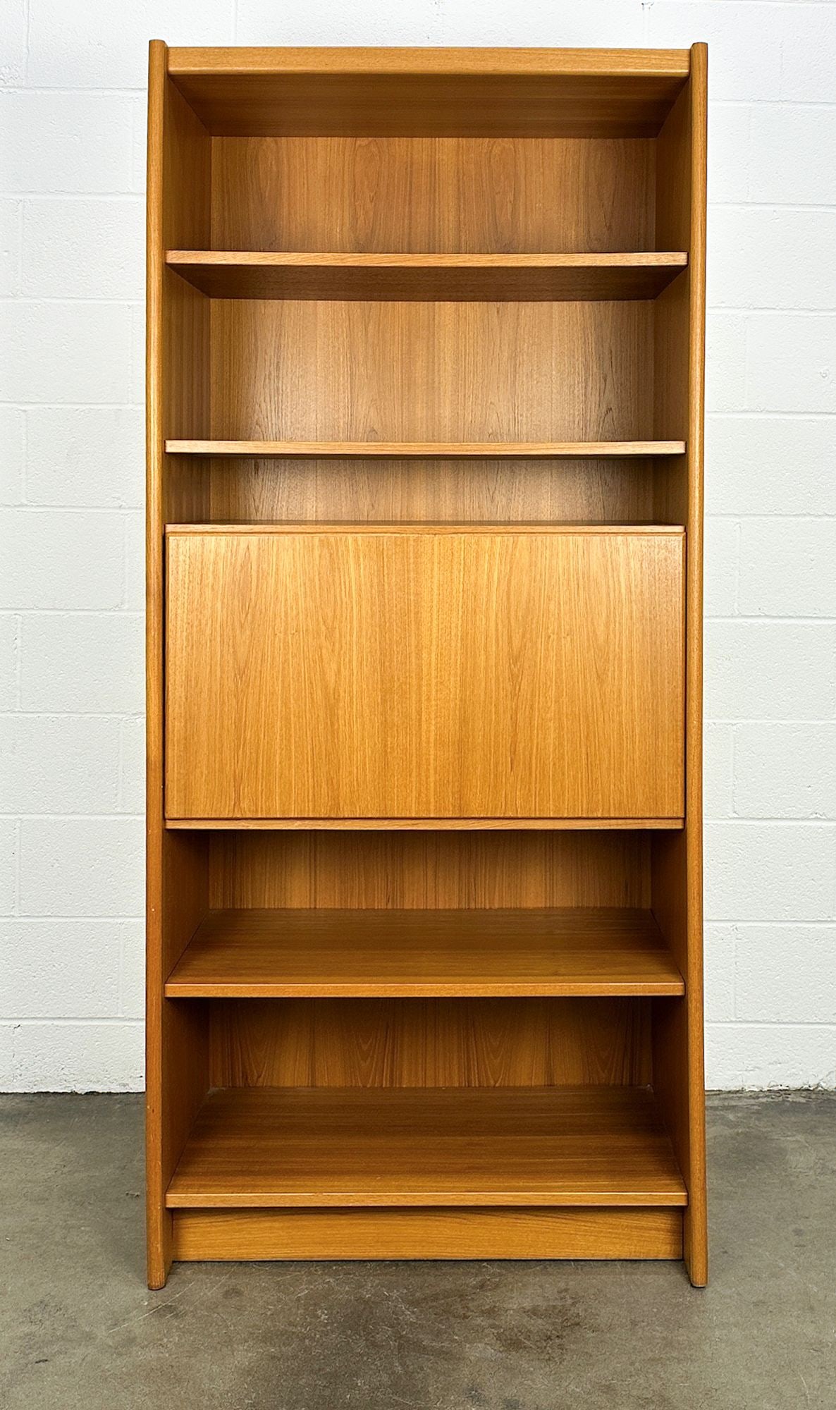 Danish Modern Teak Bookshelf Secretary Desk: Teak veneer on pressed wood. Foldable writing surface. Made in Denmark marking on back. Dimensions: Shelf is approx. 74.25 in H x 33.5 in W x 18.5 in D. LOCAL PICK UP INFORMATION:Wednesday, September