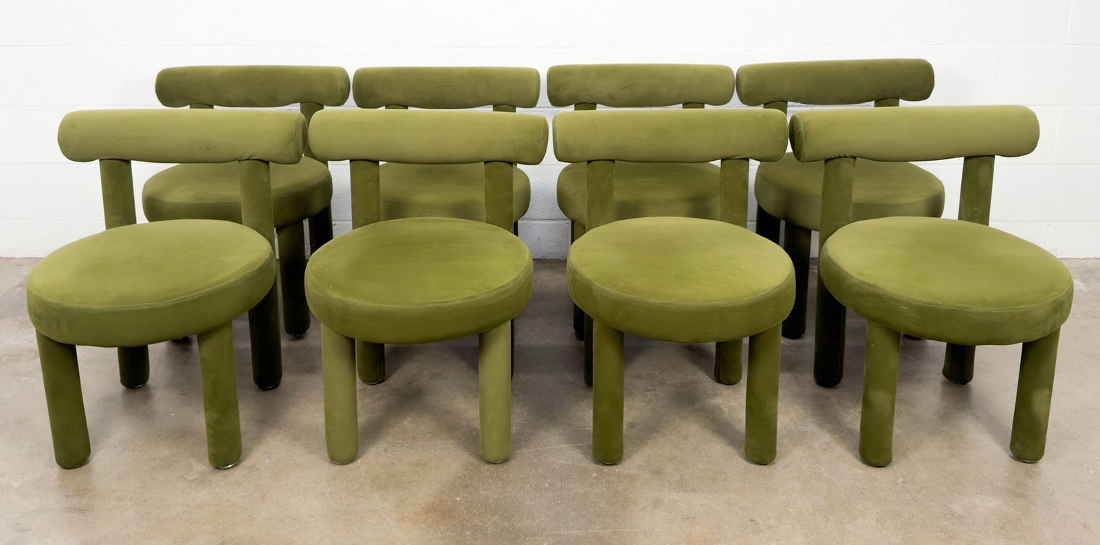 Set of 8 TOV Carmel Velvet Dining Chairs: Chairs feature cylindrical back and legs with round seat. Olive green velvet upholstery with wood wrapped in foam. Dimensions: Approximately 28.5 in H x 22 in W x 21 in D. LOCAL PICK UP