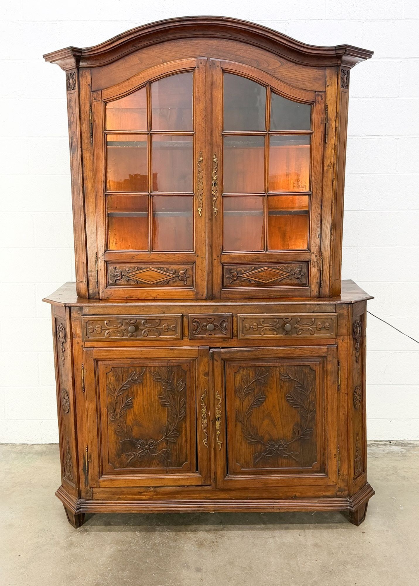 Antique Carved Oak China Hutch with Illuminated Display: Two tiered illuminated upper display case. Lower storage with three drawers. Dimensions: Approx dimensions: 86 in H x 57 in W x 18 in D. LOCAL PICK UP INFORMATION:Wednesday, September 16, 10:00
