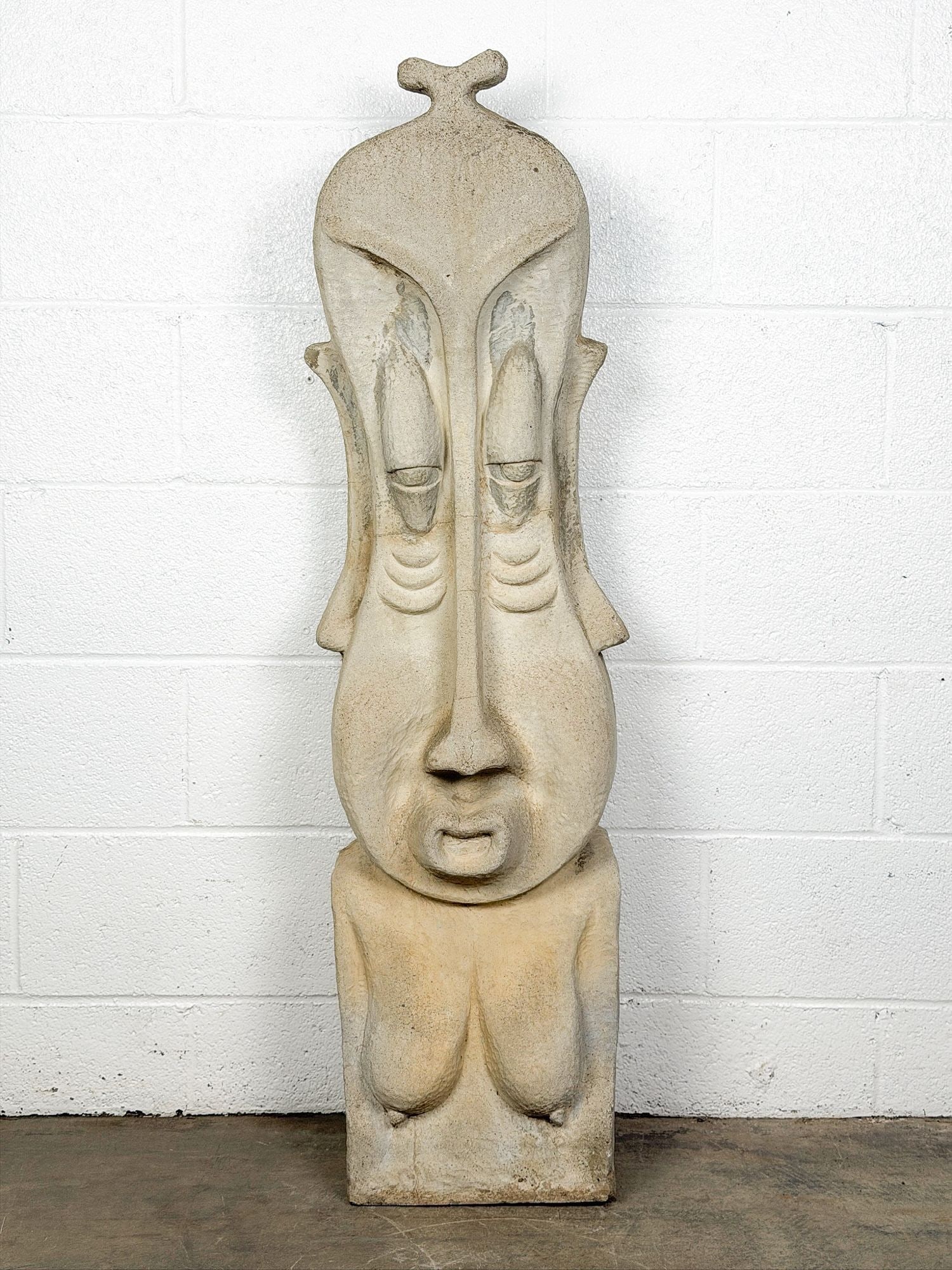 Large Cast Concrete Figural Sculpture with Folk/Tribal Motifs: Folk art or tribal motif. Elongated features. Dimensions: Sculpture is approx. 47.5 in H x 14 in W x 8.5 in D. LOCAL PICK UP INFORMATION:Wednesday, September 16, 10:00 AM-2:00 PM at 8059 Foothill Blvd