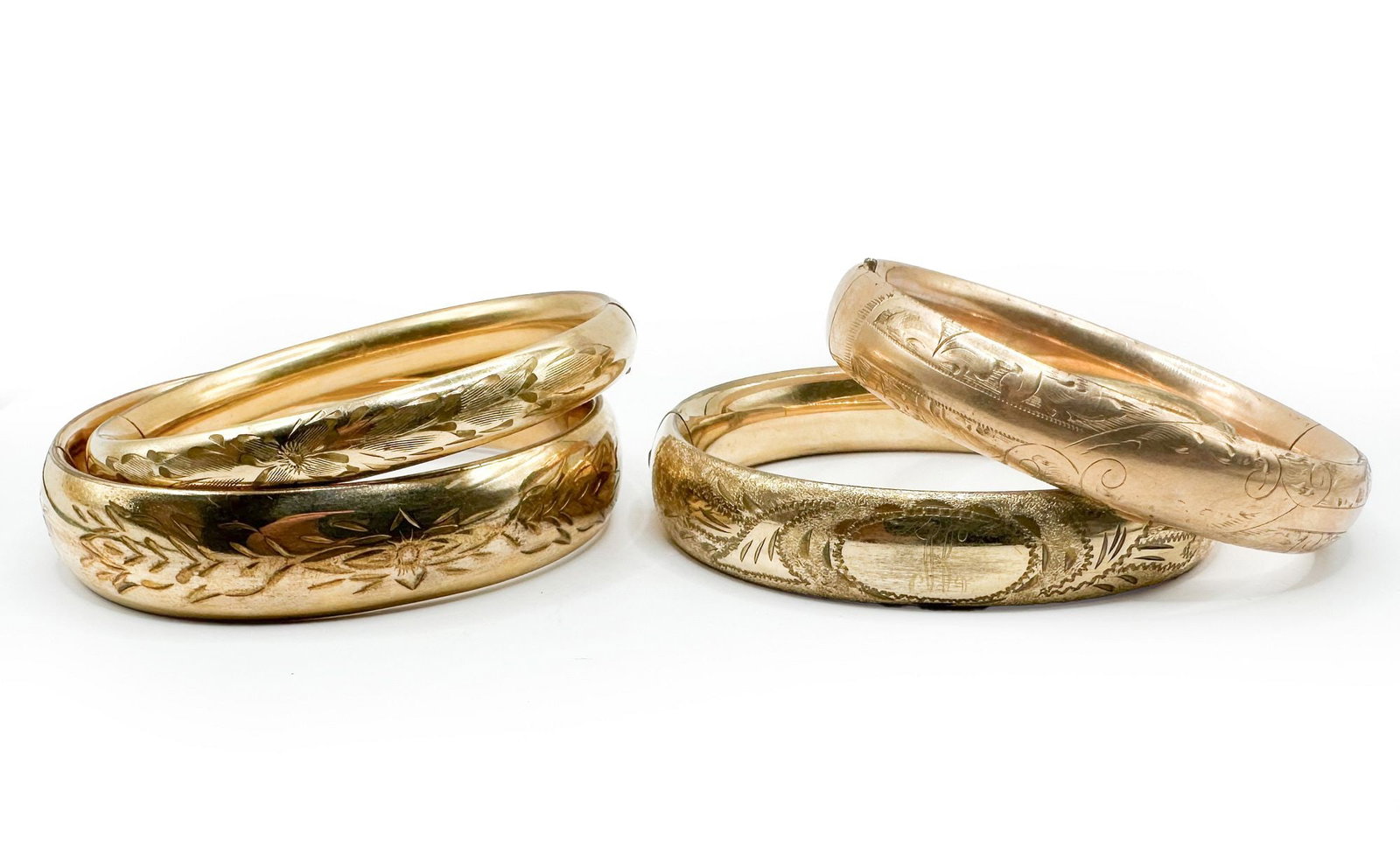 Lot of 4 Vintage Etched Gold Fill Bangles: Vintage bangles with etched designs. Some wear to surfaces, clasps function. Dimensions: Interiors are approx. 2 inches x 2.5 inches. Overall weigh 76 grams. LOCAL PICK UP INFORMATION:Wednesday, Septe