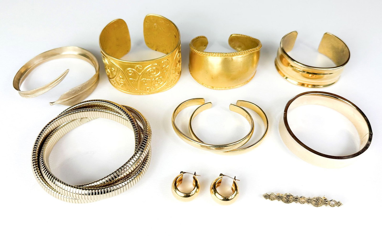 Collection of 10 Gold-Tone and Gold-Fill Bracelets, Earrings, and Brooch: Lot of 10 vintage and designer gold tone and gold fill bracelet. LOCAL PICK UP INFORMATION:Wednesday, September 16, 10:00 AM-2:00 PM at 8059 Foothill Blvd, Sunland, CA 91040 SHIPPING:Winning bidders a