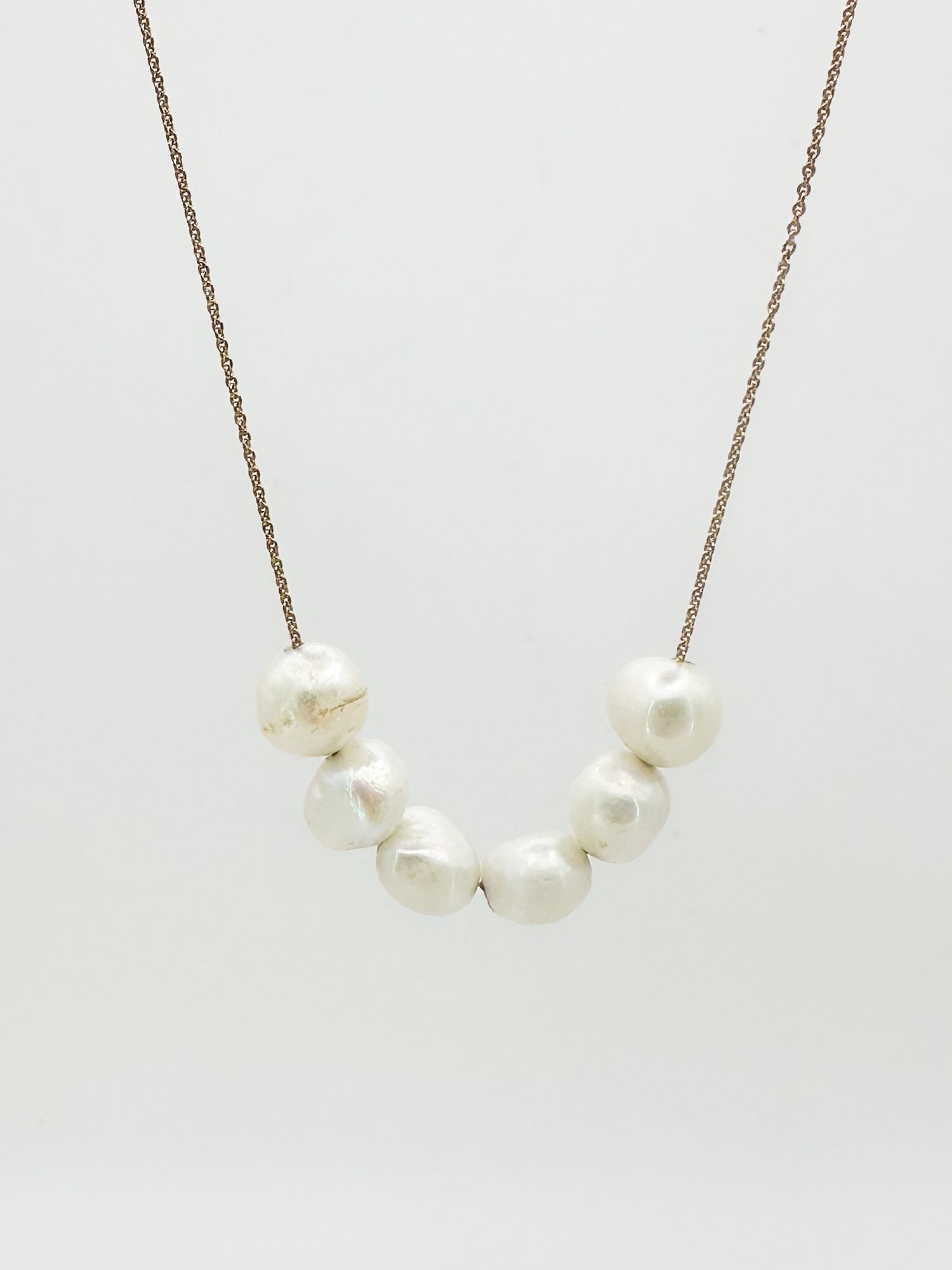 Ginette NY 18K Gold & Pearl Necklace: Ginette NY 18K gold necklace featuring a cluster of six pearls. Dimensions: Measures 17 inches in length and weighs 2.6 grams. LOCAL PICK UP INFORMATION:Wednesday, September 16, 10:00 AM-2:00 PM at 80