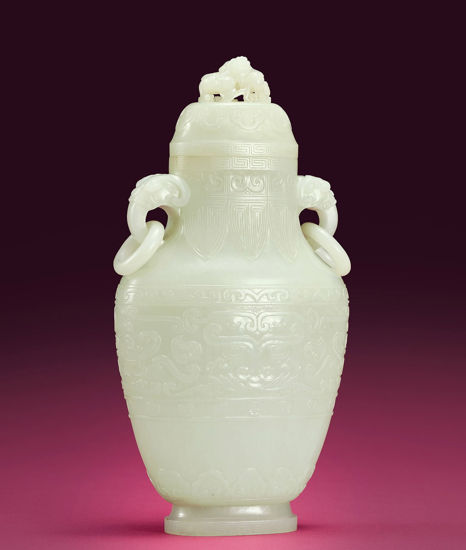 White Jade Archaic 'Beast-Mask' Vase & Cover, 18th C: 227 十八世紀 白玉獸面紋獸首銜活環耳蓋瓶 「乾隆年製」款 H