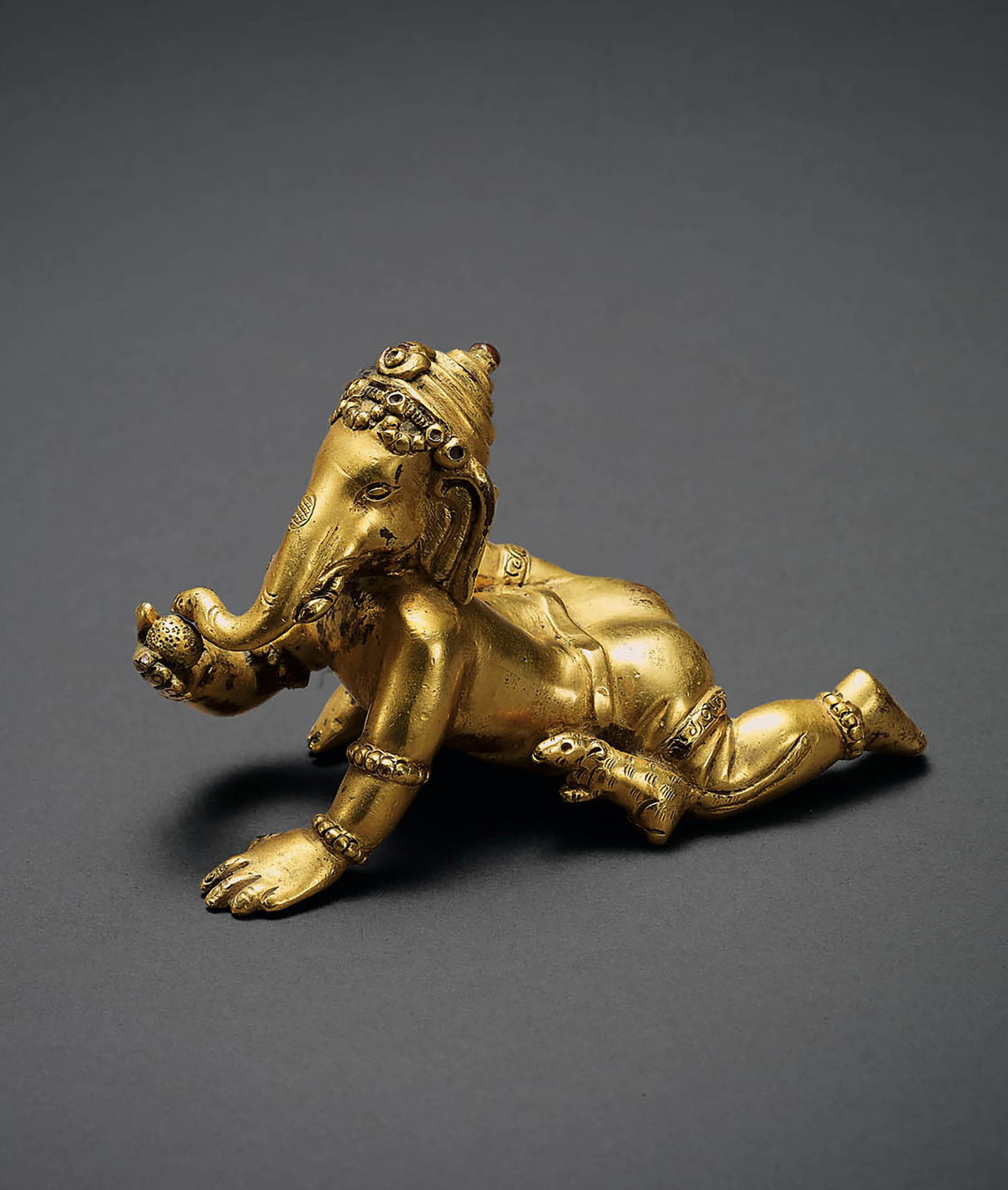 Gilt-Bronze Ganapati Figure, Qing Dynasty: 551 清 銅鎏金象頭王財神 L9.5cm 象頭王財神銅鑄鎏金，質地堅實