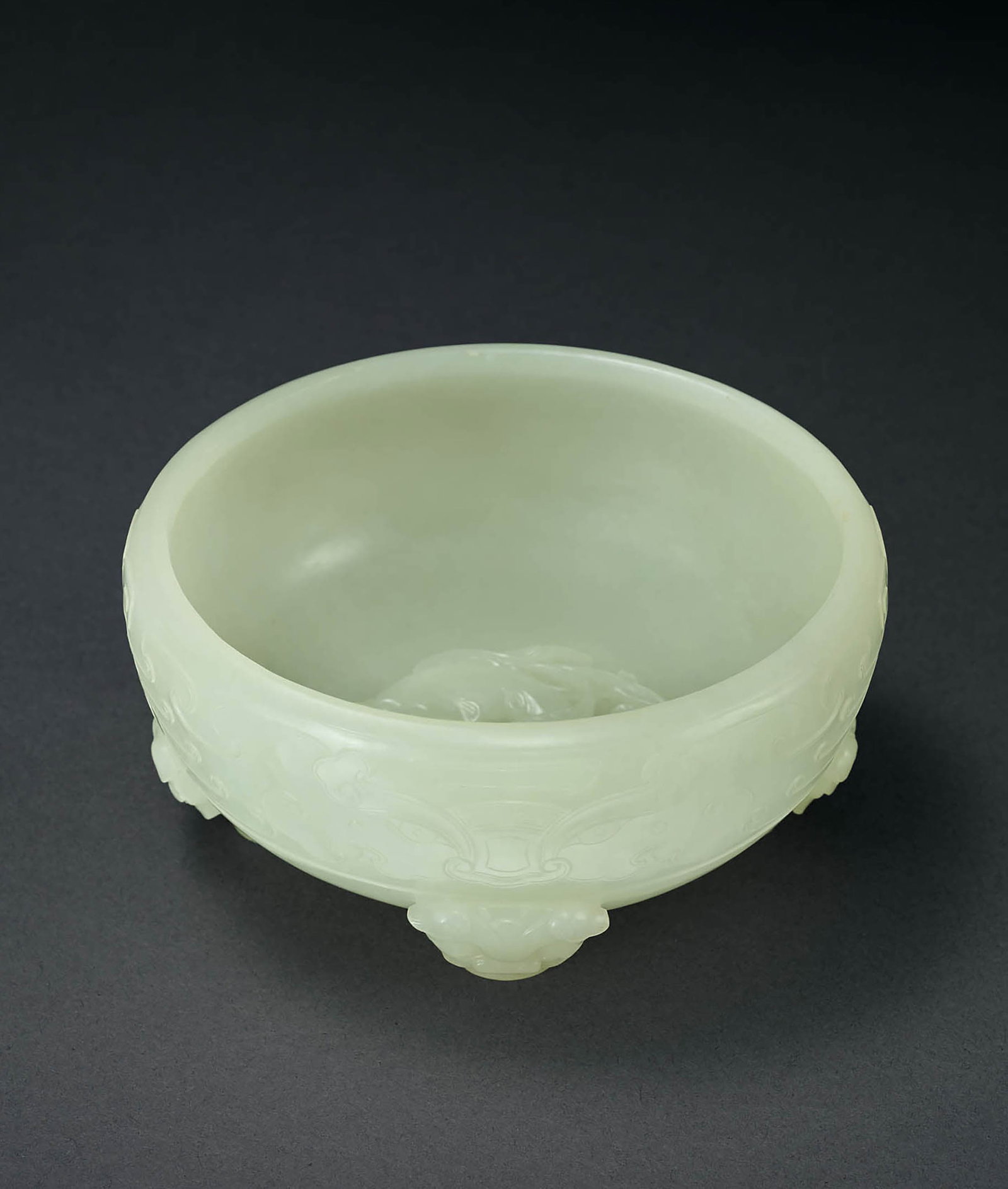 White Jade 'Beast-Mask' Brush Washer, Qing Dynasty: 585 清 白玉獸面紋四獸足洗 D10.8cm 洗取整料白玉掏膛挖製，質地&#