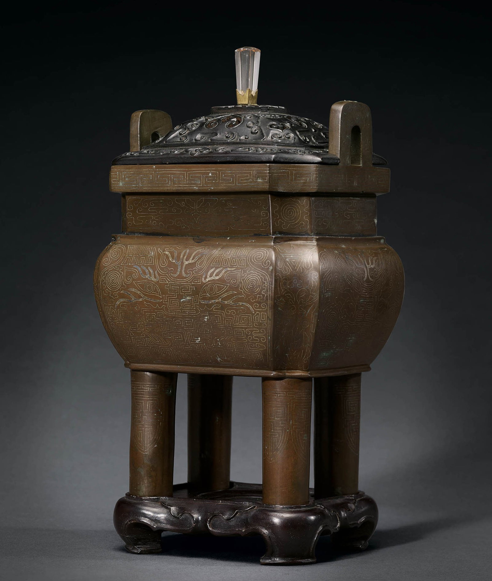 Silver-Inlaid Mythical Beast Censer, Zitan Stand, Qing: 679 清 銅嵌銀獸面紋四足鼎式爐暨紫檀座 H26cm H33cm ( 含蓋及座) Wt. 3825g 來