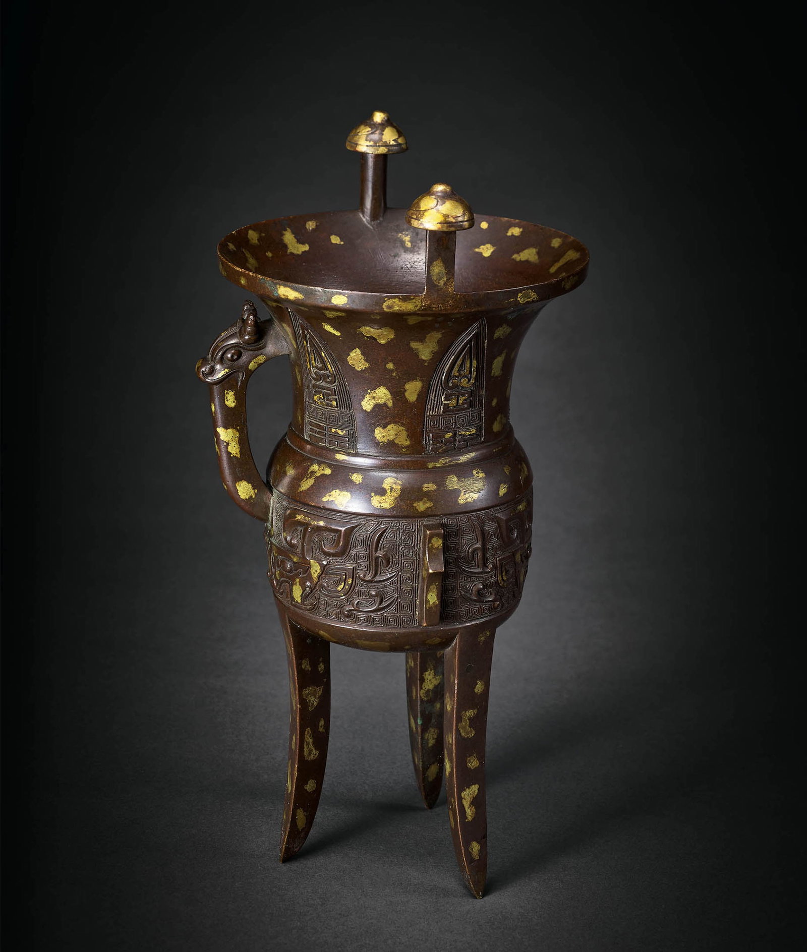 Gold-Splashed Bronze 'Beast-Mask' Jia Vessel, 17th C: 685 十七世紀 銅點金獸面紋斝 「伯申作寶彝」款 H31.5cm Wt. 2271g 斝取精