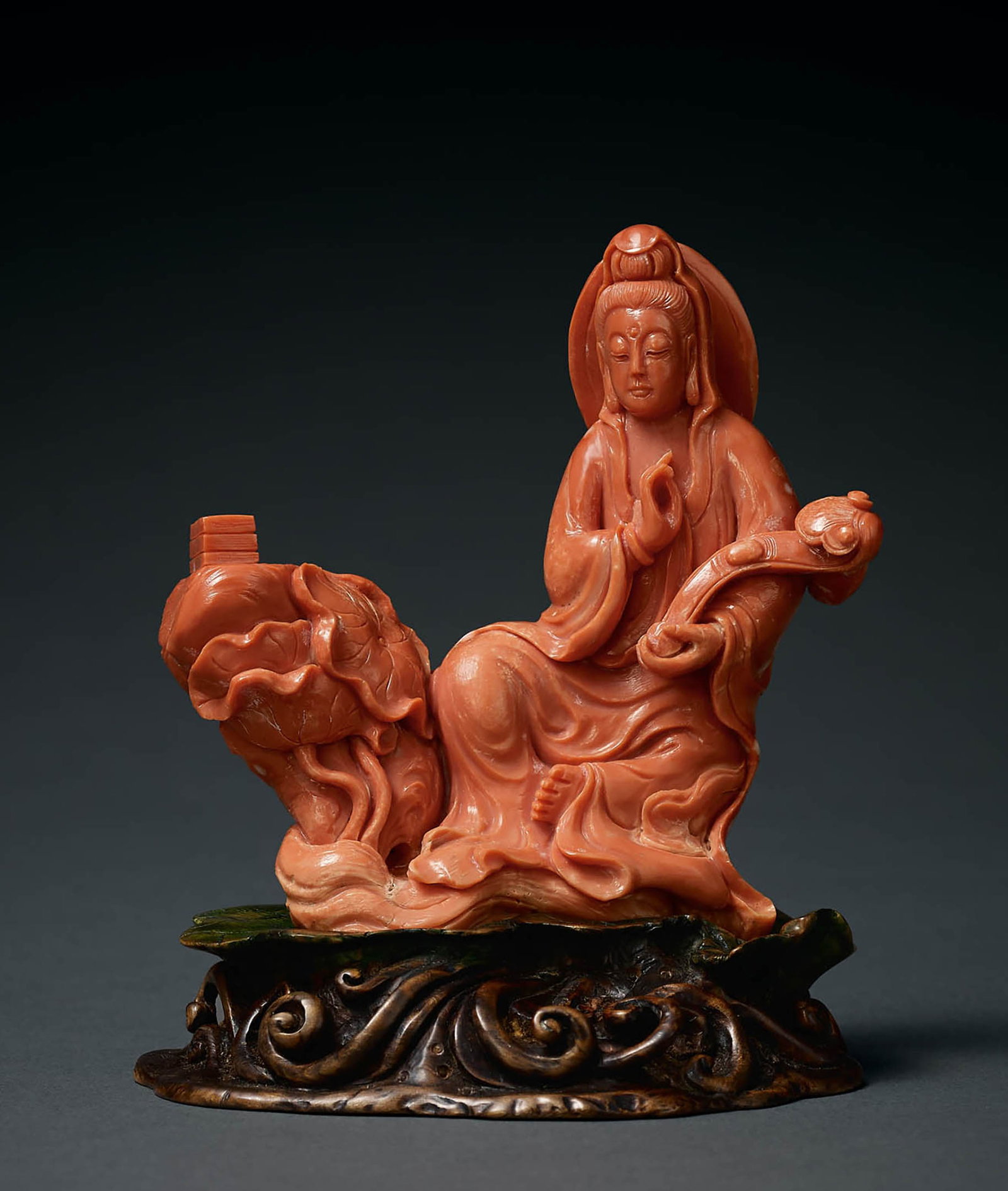 Coral Figure of Guanyin, Qing Dynasty: 697 清 珊瑚持如意觀音坐像 H12.5cm 觀音取整料上等紅珊瑚雕製而&#