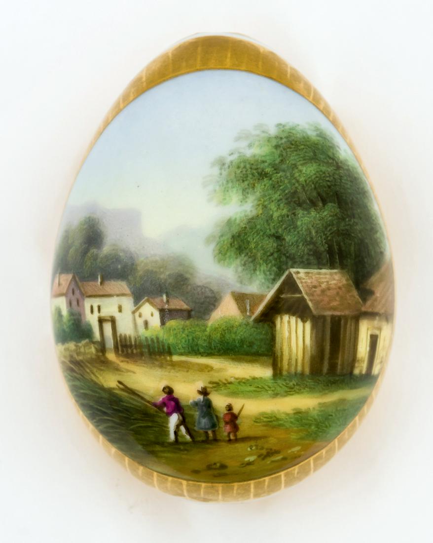 A RUSSIAN PORCELAIN EASTER EGG SHOWING A VILLAGE SCENE (1 of 2)