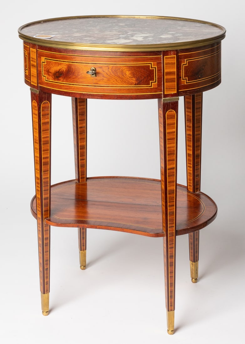 GUERIDON WITH MARBLE TOP IN LOUIS XVI STYLE: Bern, manufactured by Heinz Müller, 20th c. 72,5 x 52,5 x 43 cm Heinz Müller was an ébéniste based in Bern who was the last to represent Bern furniture art of the 18th