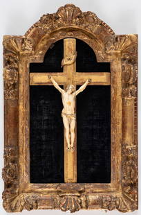 CRUCIFIX: mounted on a velvet base, in a baroque frame (slightly chipped), 18th c. Height of body: 20 cm, frame: 54 x 36 cm